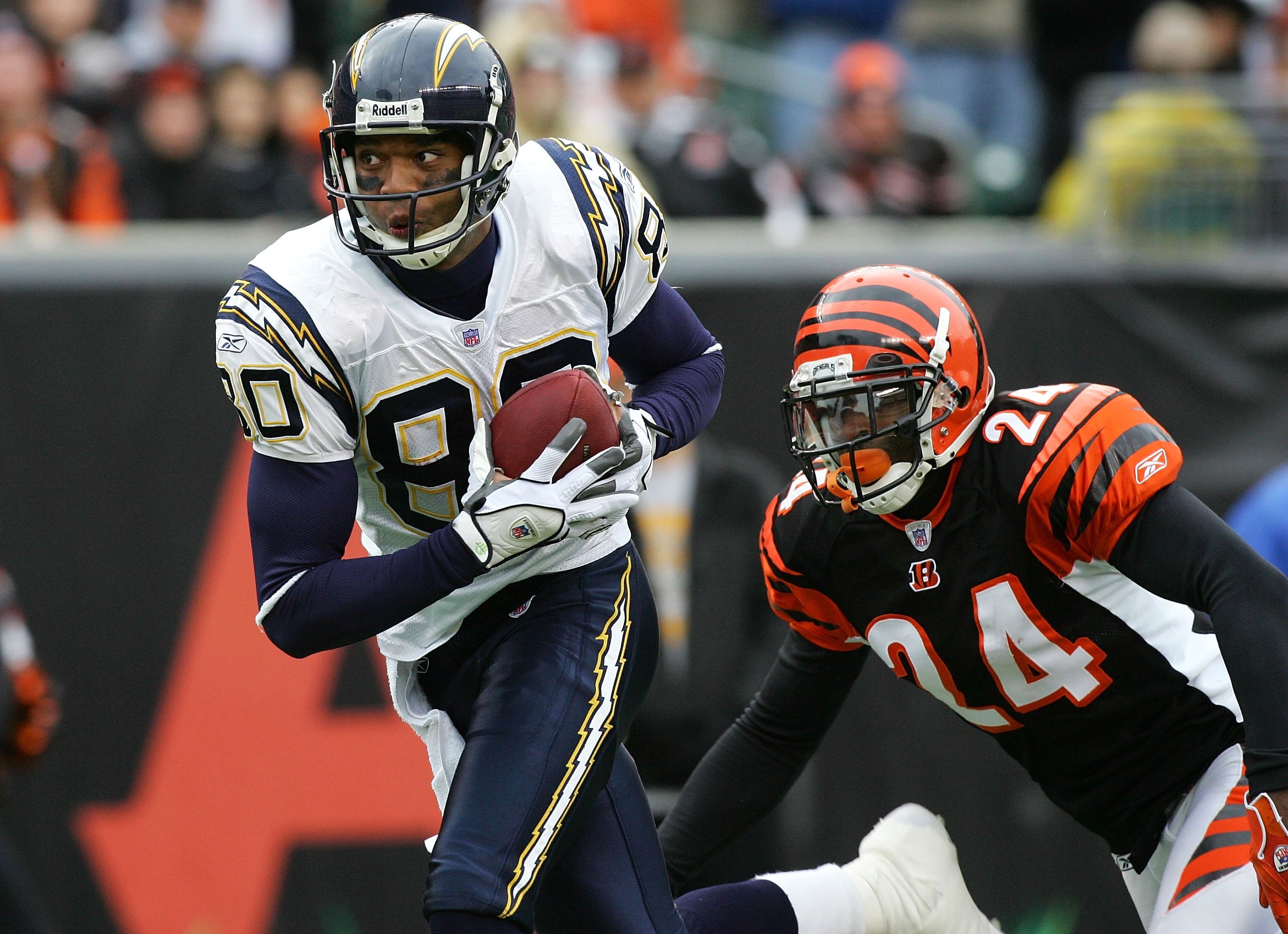 CINCINNATI - NOVEMBER 12:  Malcolm Floyd #80 San Diego Chargers runs in a touchdown reception against Deltha O'Neal #24 of the Cincinnati Bengals on November 12, 2006 at Paul Brown Stadium in Cincinnati, Ohio. The Chargers defeated the Bengals 49-41.  (Ph