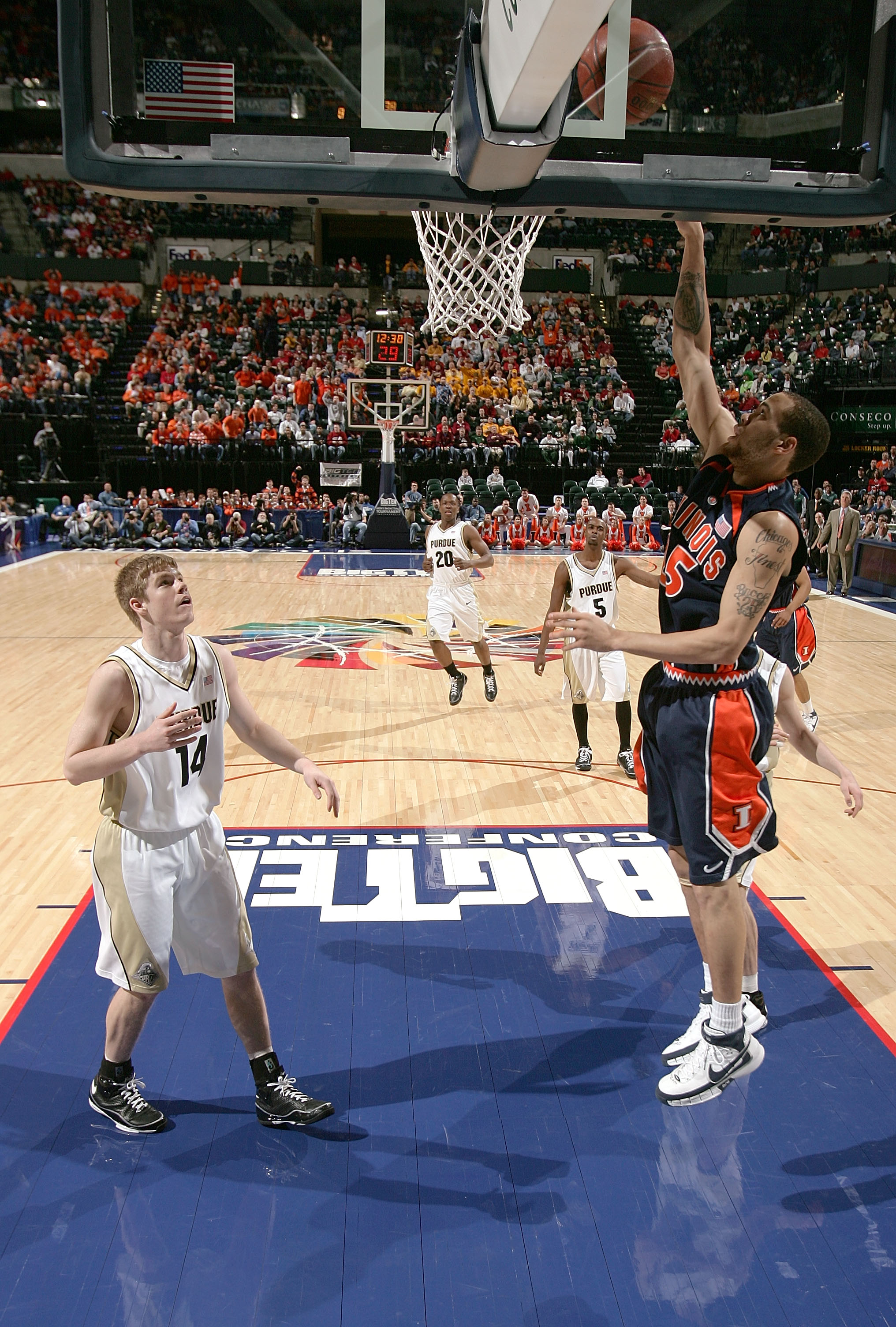 INDIANAPOLIS - MARCH 14:  Calvin Brock #25 of the Illinois Fighting Illini attempts a shot against Scott Martin #14 of the Purdue Boilermakers during the Big Ten Men's Basketball Tournament at Conseco Fieldhouse on March 14, 2008 in Indianapolis, Indiana.