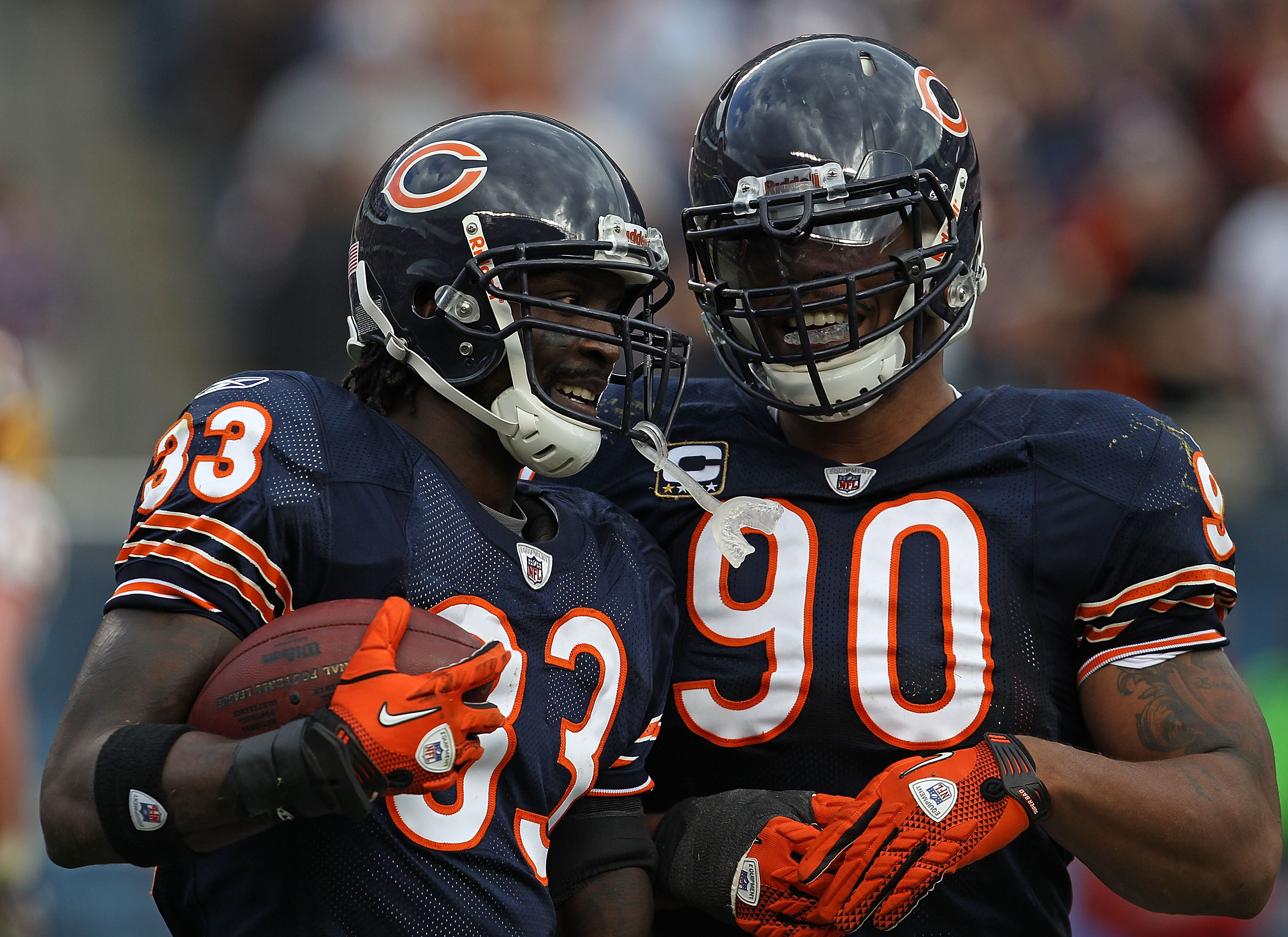 Chicago Bears cornerback Charles Tillman (33) and safety Chris Harris (46)  pull on New York Giants wide receiver Hakeem Nicks' (88) jersey, stoping a  big run after a Nicks' reception during second