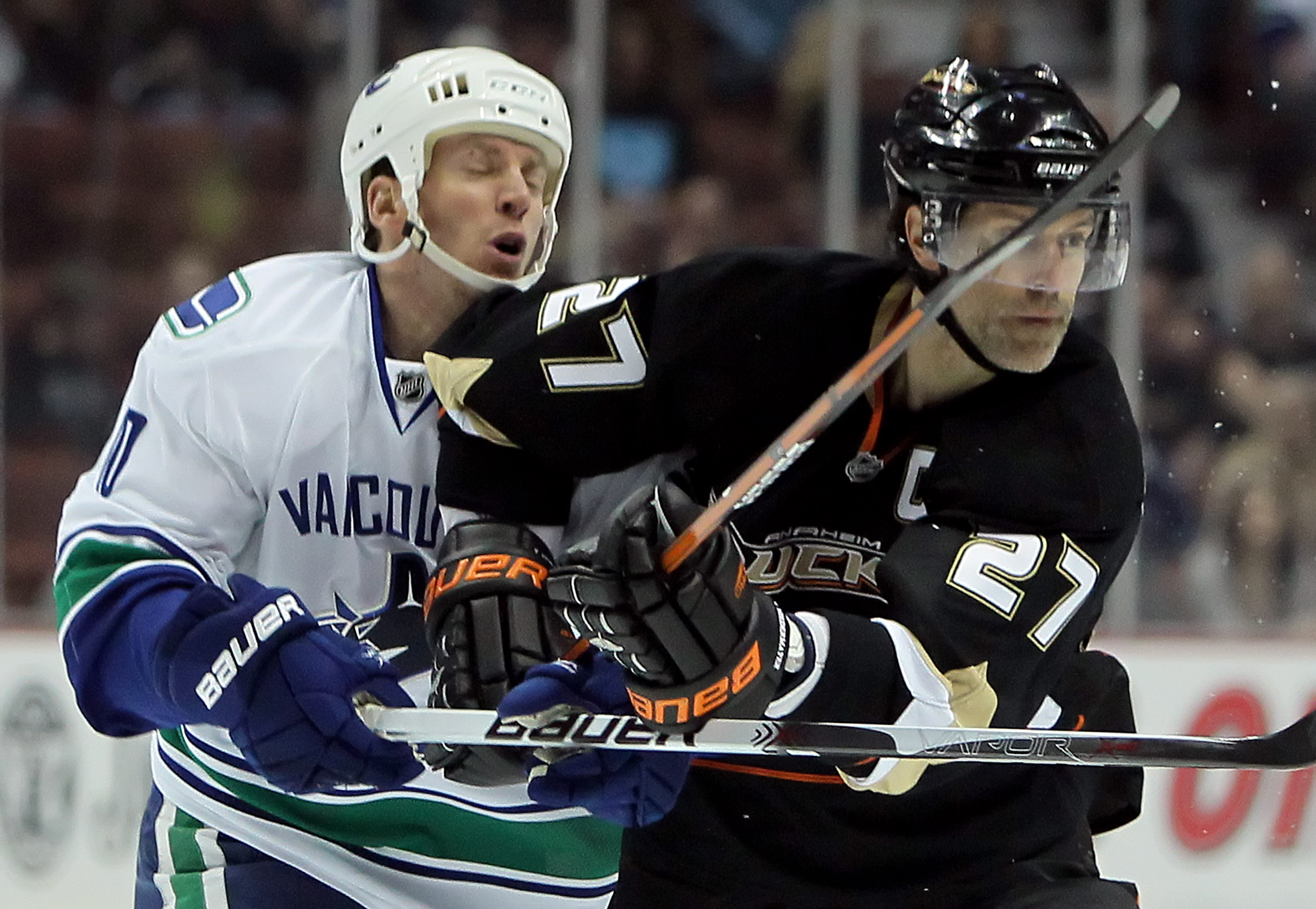 ANAHEIM, CA - APRIL 02:  Ryan Johnson #10 of the Vancouver Canucks is elbowed by Scott Niedermayer #27 of the Anaheim Ducks in the first period at the Honda Center on April 2, 2010 in Anaheim, California.  (Photo by Jeff Gross/Getty Images)