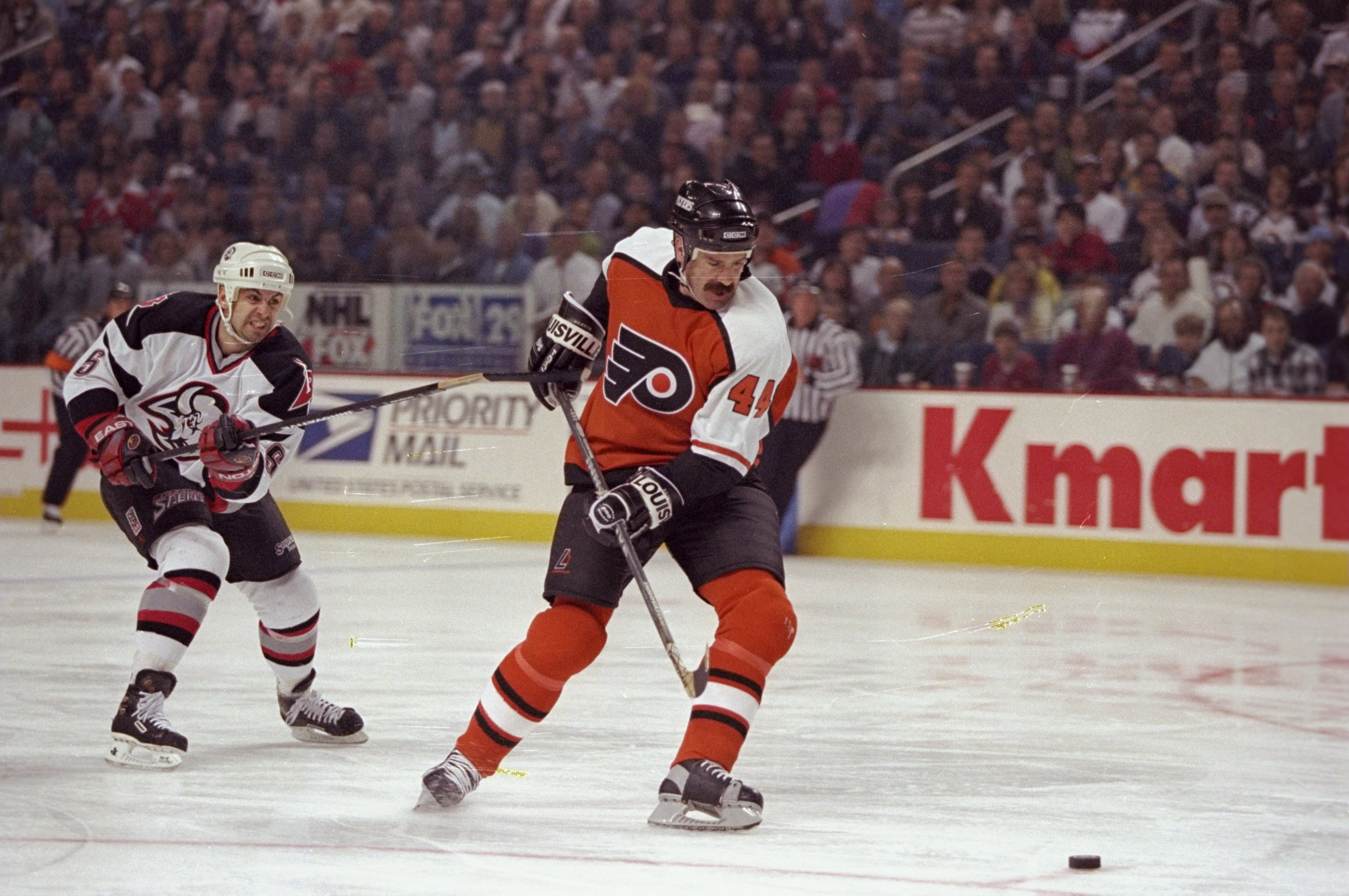 27 Apr 1998:  Defenseman Dave Babych of the Philadelphia Flyers in action against defenseman Jason Woolley of the Buffalo Sabres during their NHL Playoffs game at the Marine Midland Arena in Buffalo, New York.  The Sabres defeated the Flyers 6-1. Mandator