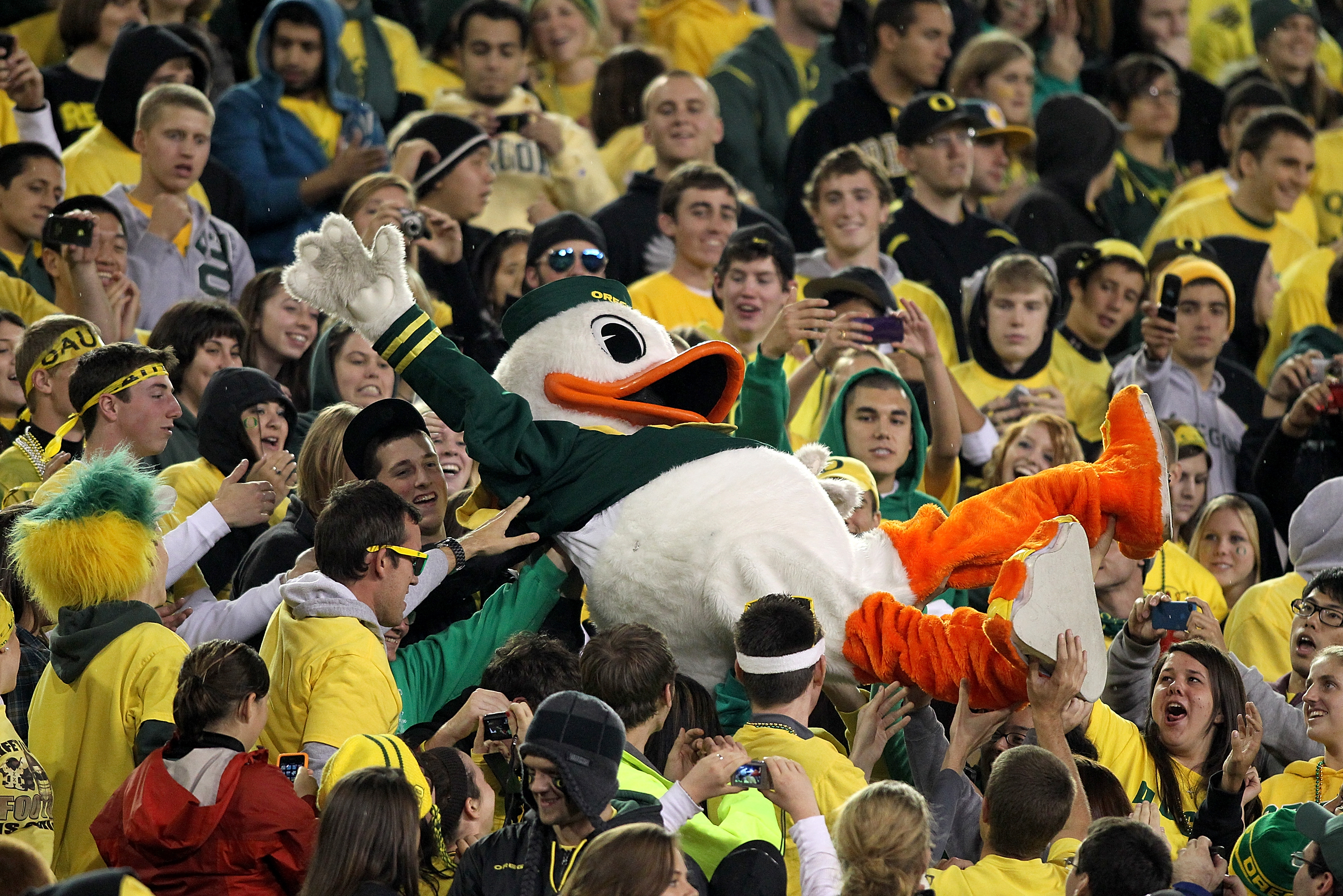EUGENE, OR - OCTOBER 21: The Oregon Duck mascot is lifted into the crowd during the game against the UCLA Bruins on October 21, 2010 at the Autzen Stadium in Eugene, Oregon. (Photo by Jonathan Ferrey/Getty Images)