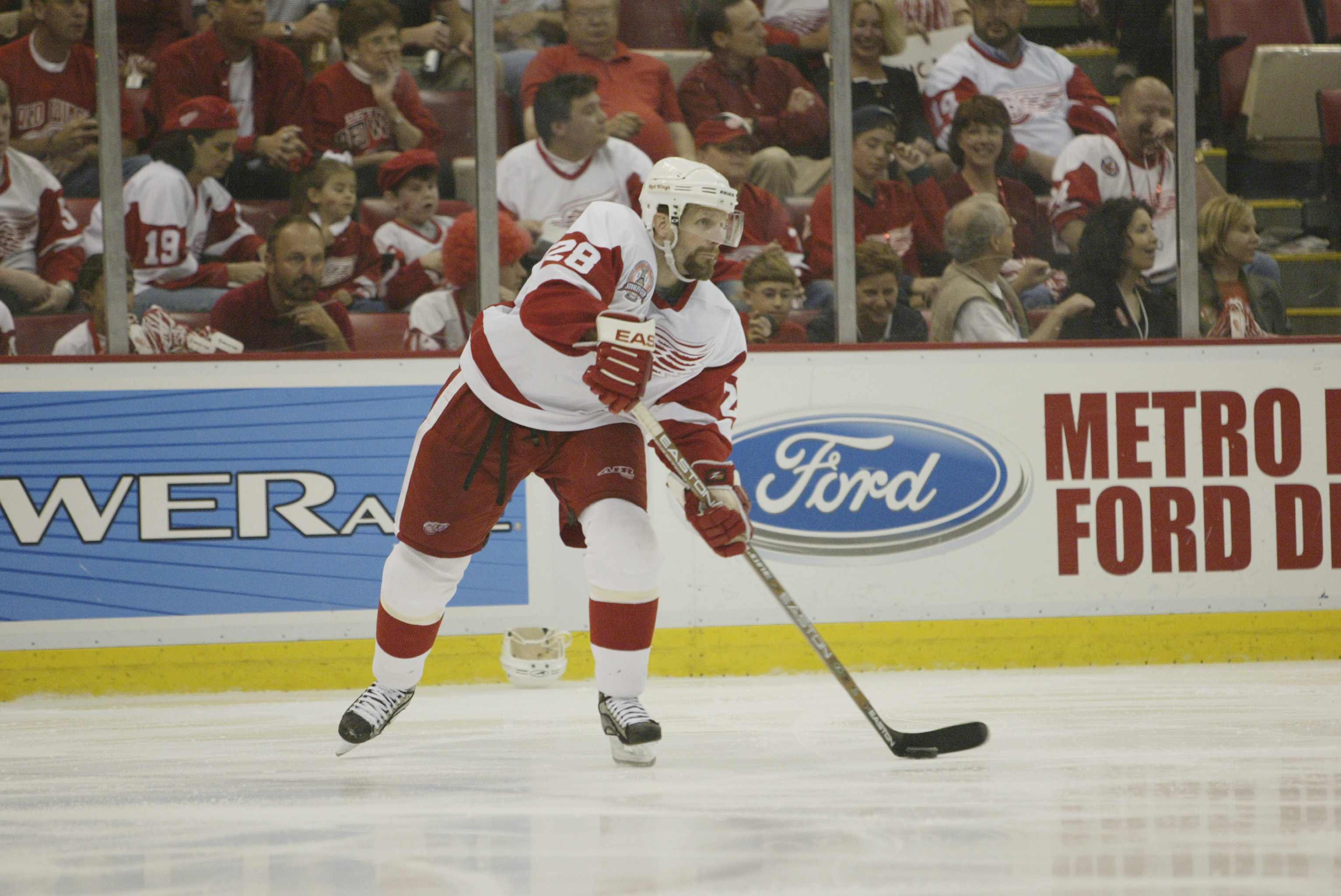 DETROIT, MI - JUNE 13:  Defenseman Steve Duchesne #28 of the Detroit Red Wings skates with the puck against the Carolina Hurricanes during game five of the NHL Stanley Cup Finals on June 13, 2002 at the Joe Louis Arena in Detroit, Michigan.  The Red Wings