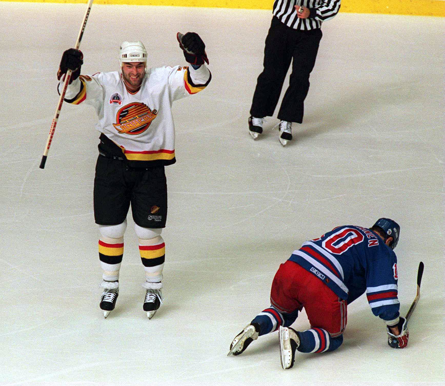 11 Jun 1994: CANUCKS DEFENSEMAN JEFF BROWN CELEBRATES AFTER SCORING TO PUT HIS TEAM UP 1-0 DURING THE FIRST PERIOD OF GAME SIX OF THE STANLEY CUP FINALS AGAINST THE RANGERS IN VANCOUVER, BRITISH COLUMBIA. AT RIGHT IS FALLEN RANGER''S WINGER ESA TIKKANEN.