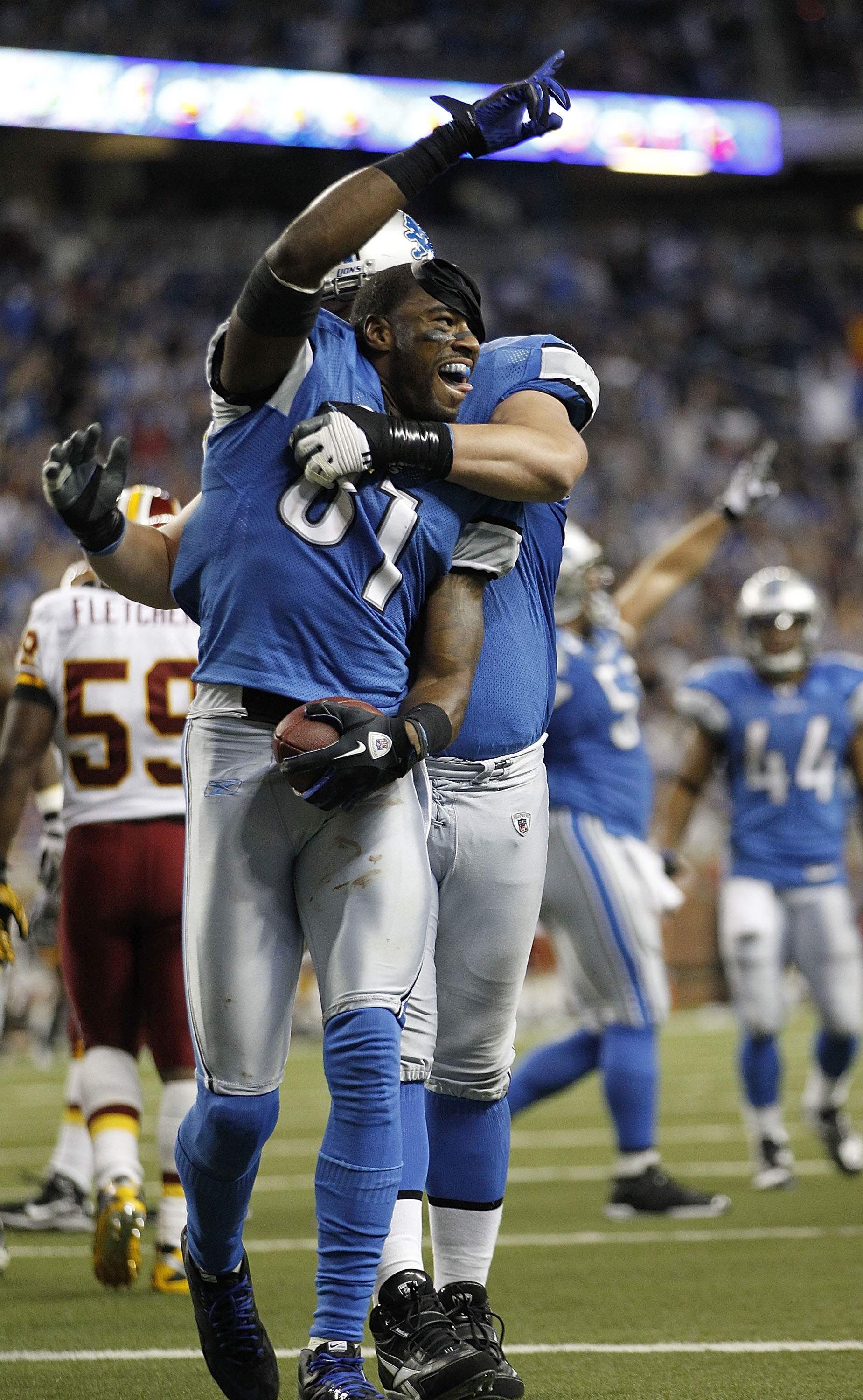 DETROIT - OCTOBER 31: Calvin Johnson #81 of the Detroit Lions celebrates with teammate Jeff Backus #76 after scoring a touchdown during the fourth quarter of the game against the Washington Redskins at Ford Field on October 31, 2010 in Detroit, Michigan. 