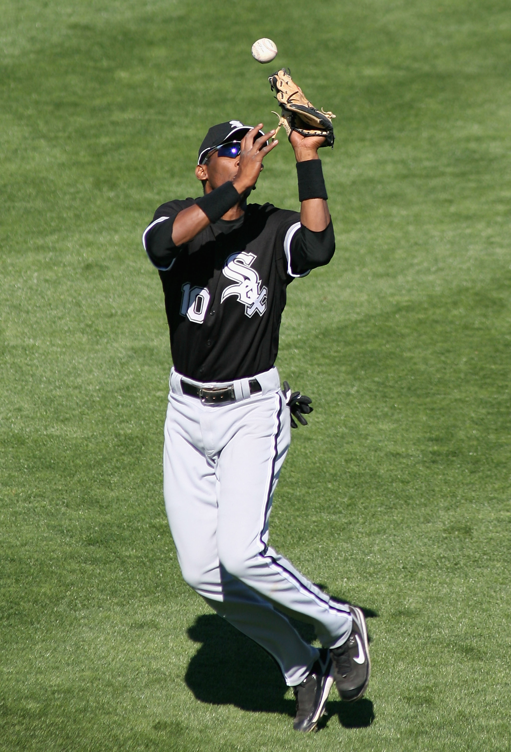 SURPRISE, AZ - MARCH 03:  Outfielder Alexi Ramirez #10 of the Chicago White Sox drops a fly ball for an error during the spring training game against the Kansas City Royals at Surprise Stadium March 3, 2008 in Surprise, Arizona.  (Photo by Christian Peter