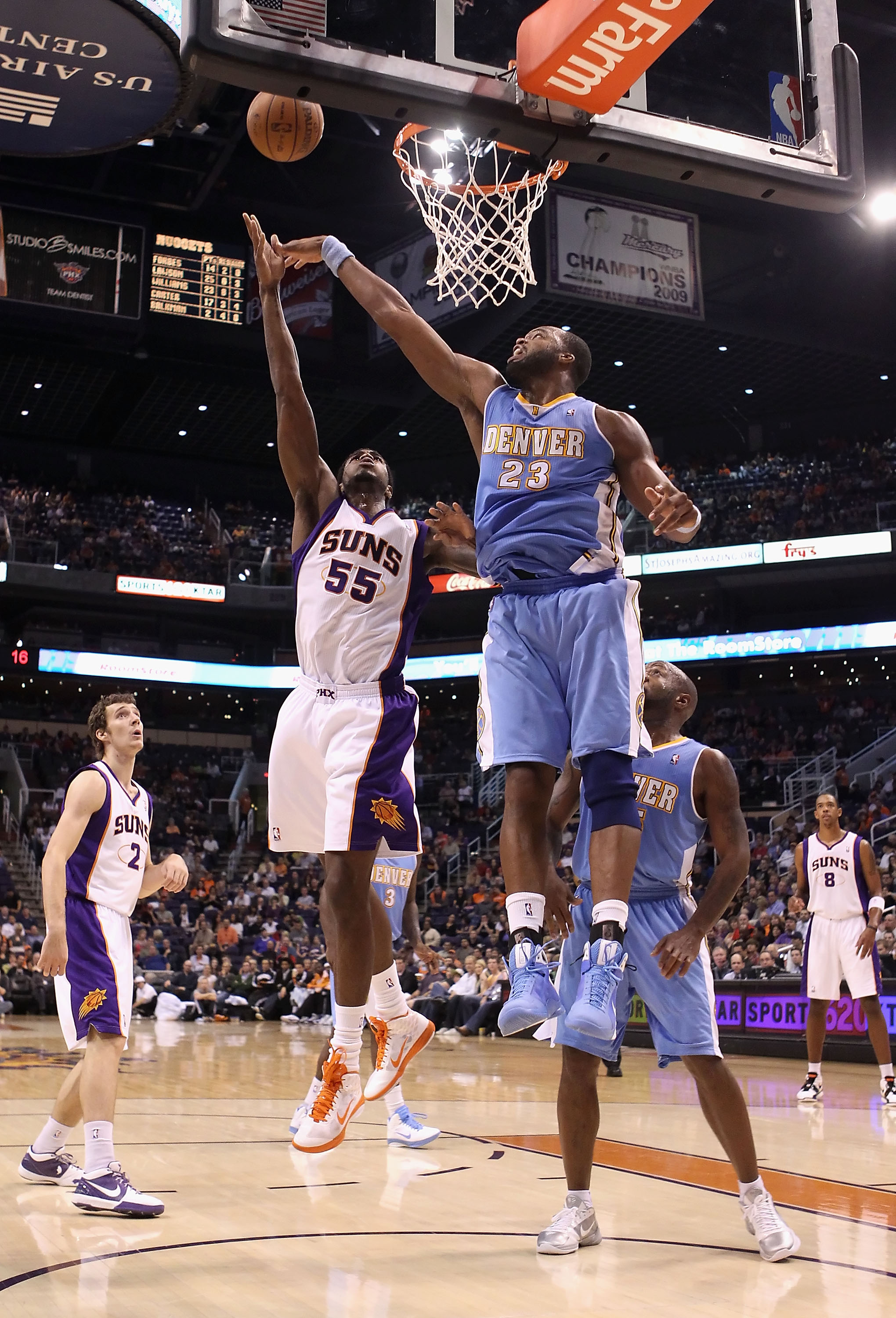 PHOENIX - OCTOBER 22:  Earl Clark #55 of the Phoenix Suns puts up a shot against Shelden Williams #23 of the Denver Nuggets during the preseason NBA game at US Airways Center on October 22, 2010 in Phoenix, Arizona. NOTE TO USER: User expressly acknowledg
