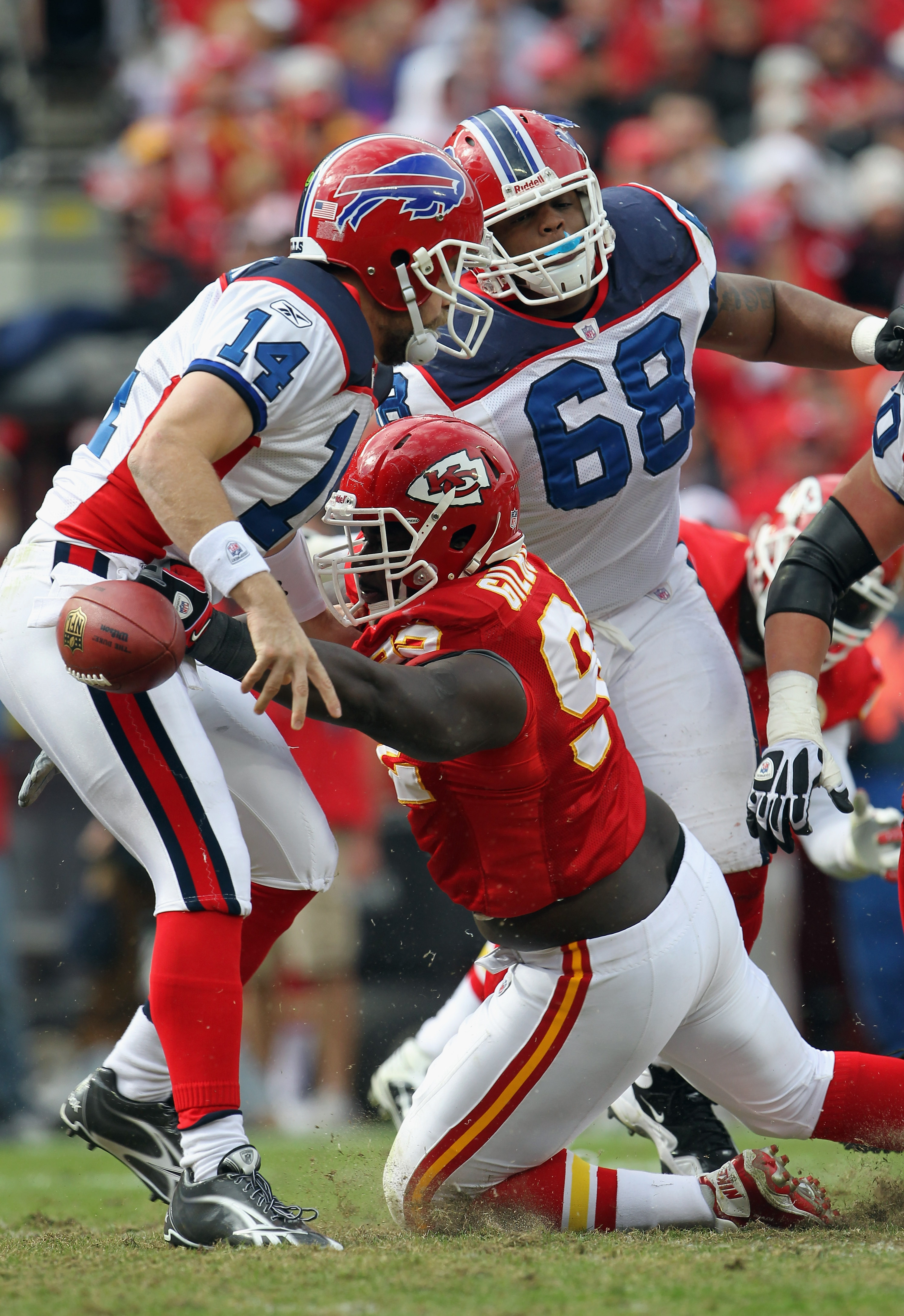 Buffalo Bills quarterback Ryan Fitzpatrick (14) ends up at the pile during  the NFL football game between the Kansas City Chiefs and the Buffalo Bills  at Arrowhead Stadium in Kansas City, Missouri.