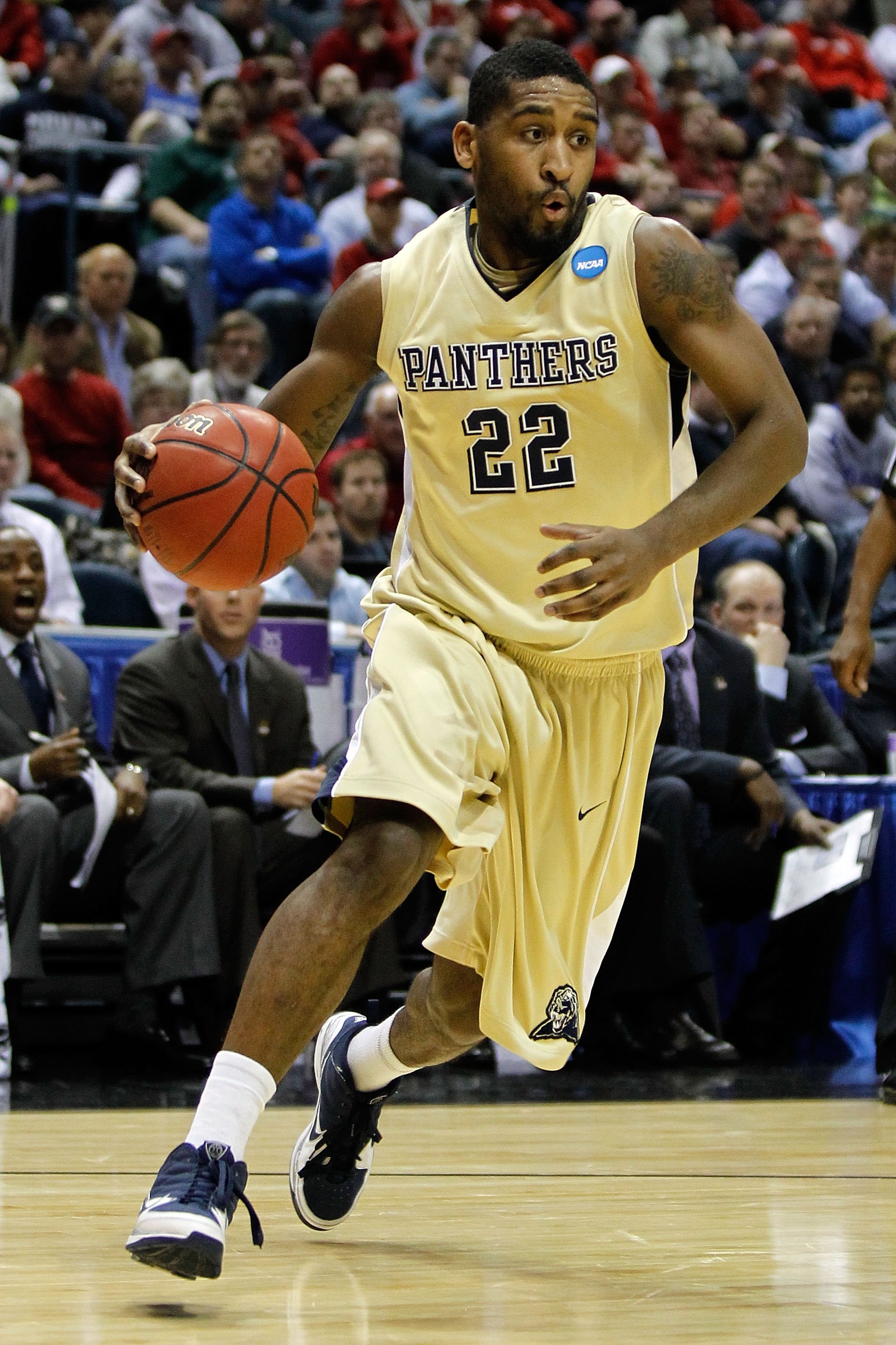 Butler center Andrew Smith (44) puts up a go-ahead score against Pittsburgh  guard Ashton Gibbs (12) with only seconds remaining in a third-round game  of the 2011 NCAA Men's Basketball Championship tournament
