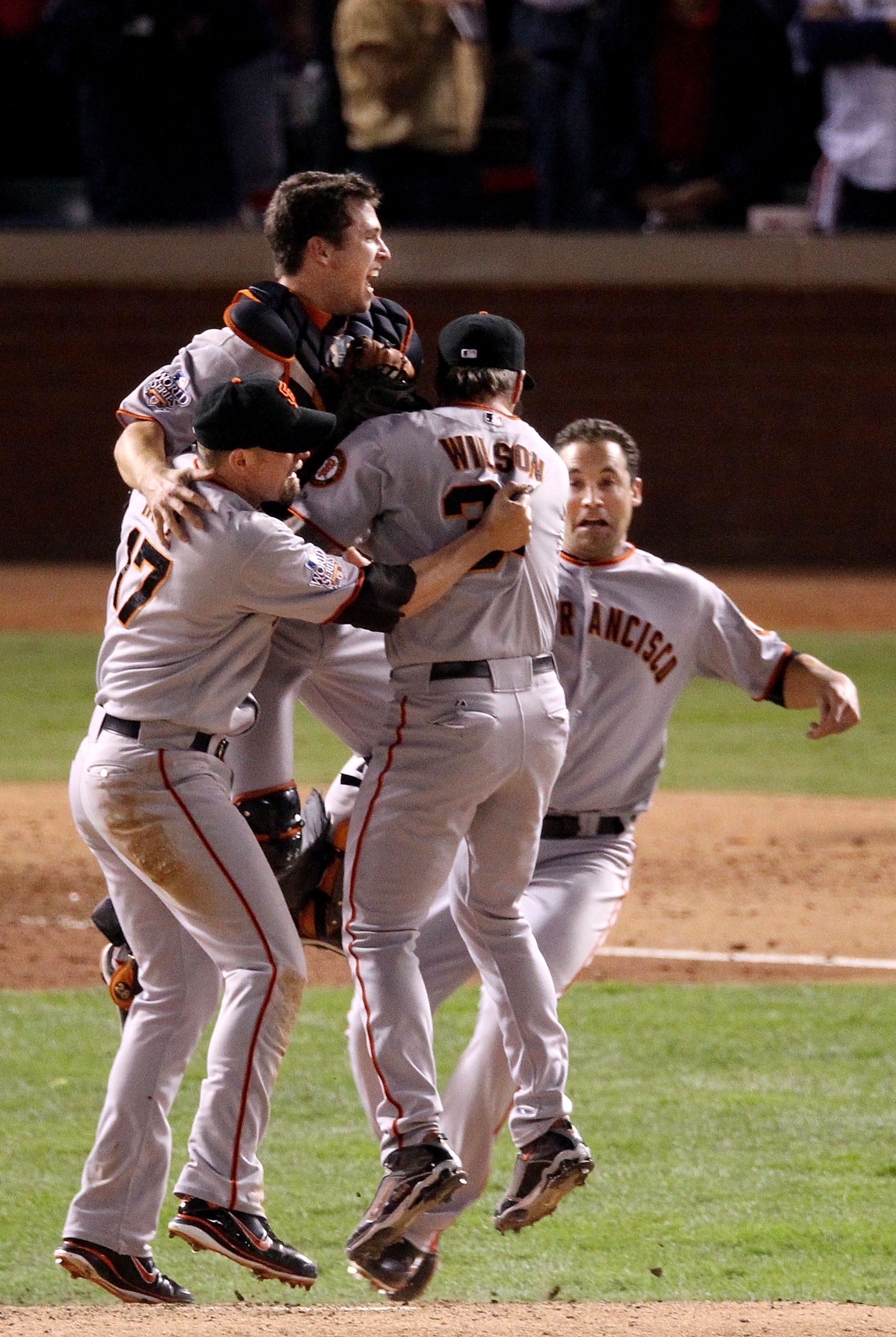 Buster Posey celebrates with the World Series Trophy.