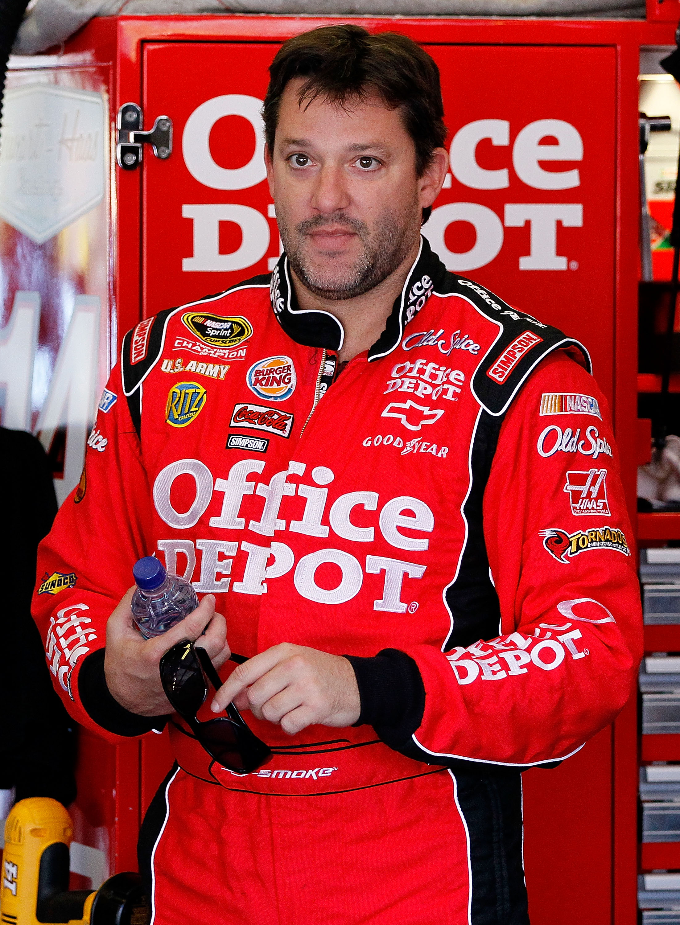 TALLADEGA, AL - OCTOBER 29:  Tony Stewart, driver of the #14 Old Spice/Office Depot Chevrolet, stands in the garage during practice for the NASCAR Sprint Cup Series AMP Energy Juice 500 at Talladega Superspeedway on October 29, 2010 in Talladega, Alabama.