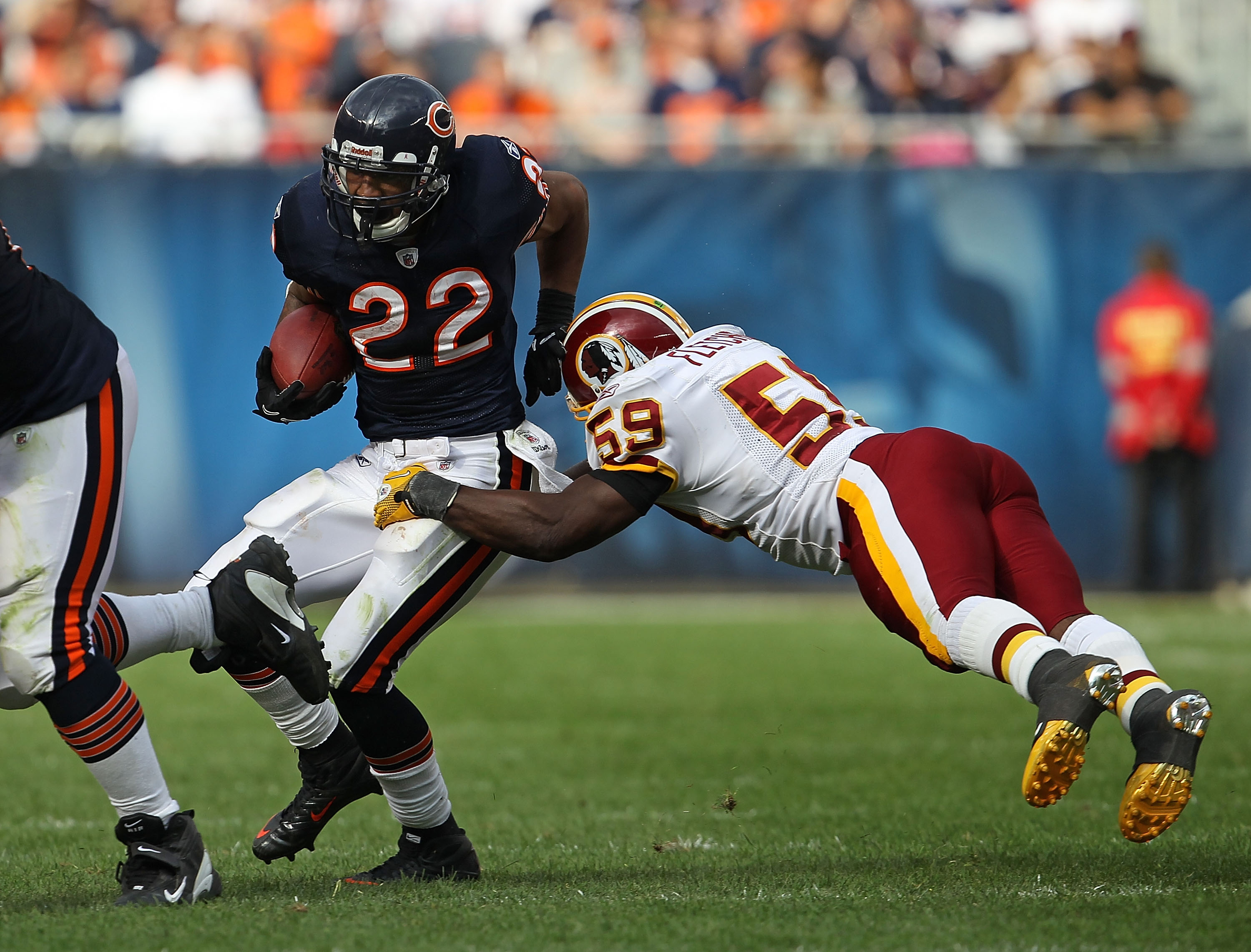 CHICAGO - OCTOBER 24: Matt Forte #22 of the Chicago Bears avoids a tackle attempt by London Fletcher #59 of the Washington Redskins at Soldier Field on October 24, 2010 in Chicago, Illinois. The Redskins defeated the Bears 17-14. (Photo by Jonathan Daniel
