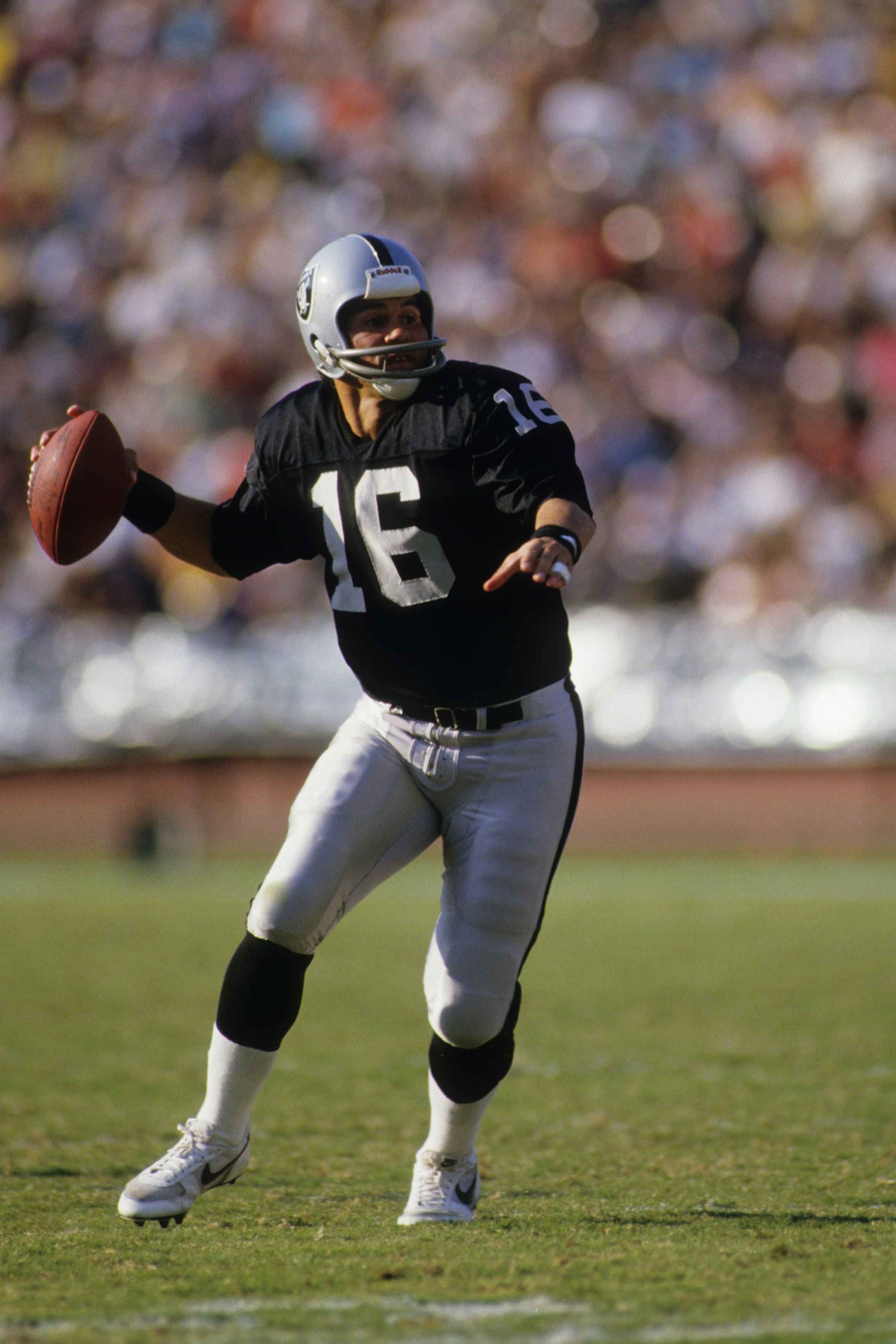 Quarterback Jim Plunkett of the Los Angeles Raiders drops back to