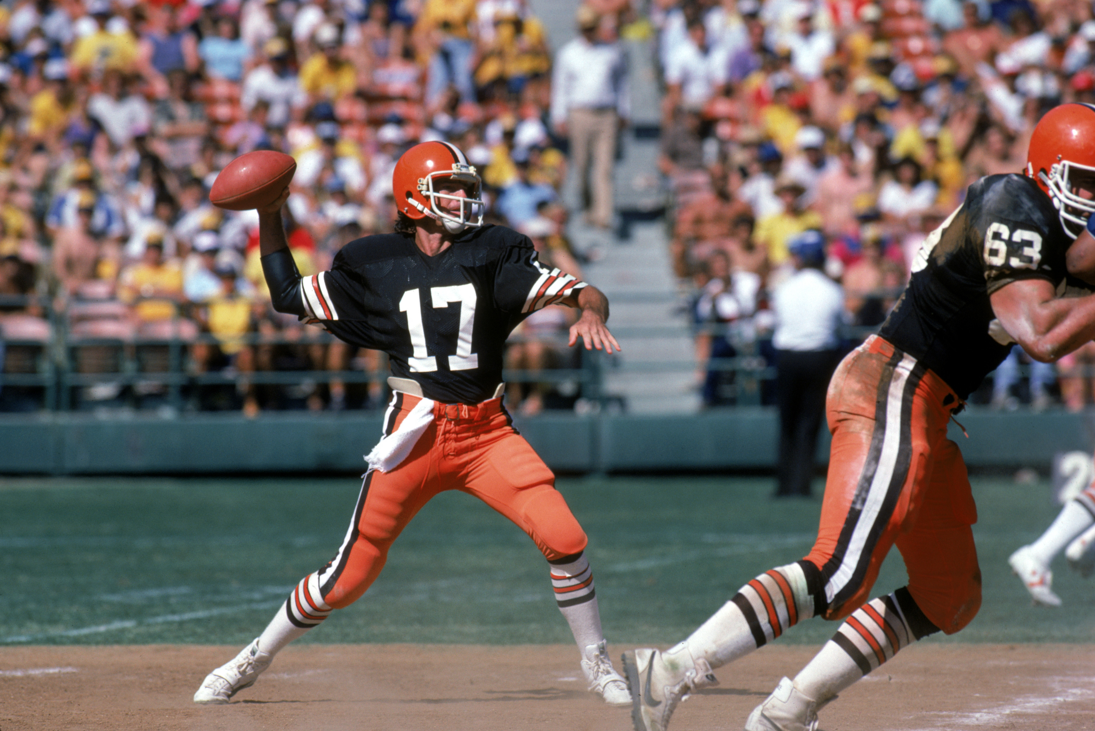 SAN DIEGO - SEPTEMBER 25: Quarterback Brian Sipe #17 of the Cleveland Browns throws a pass under the protection of offensive tackle Cody Risien #63 during a game against the San Diego Chargers at Jack Murphy on September 25, 1983 in San Diego, California