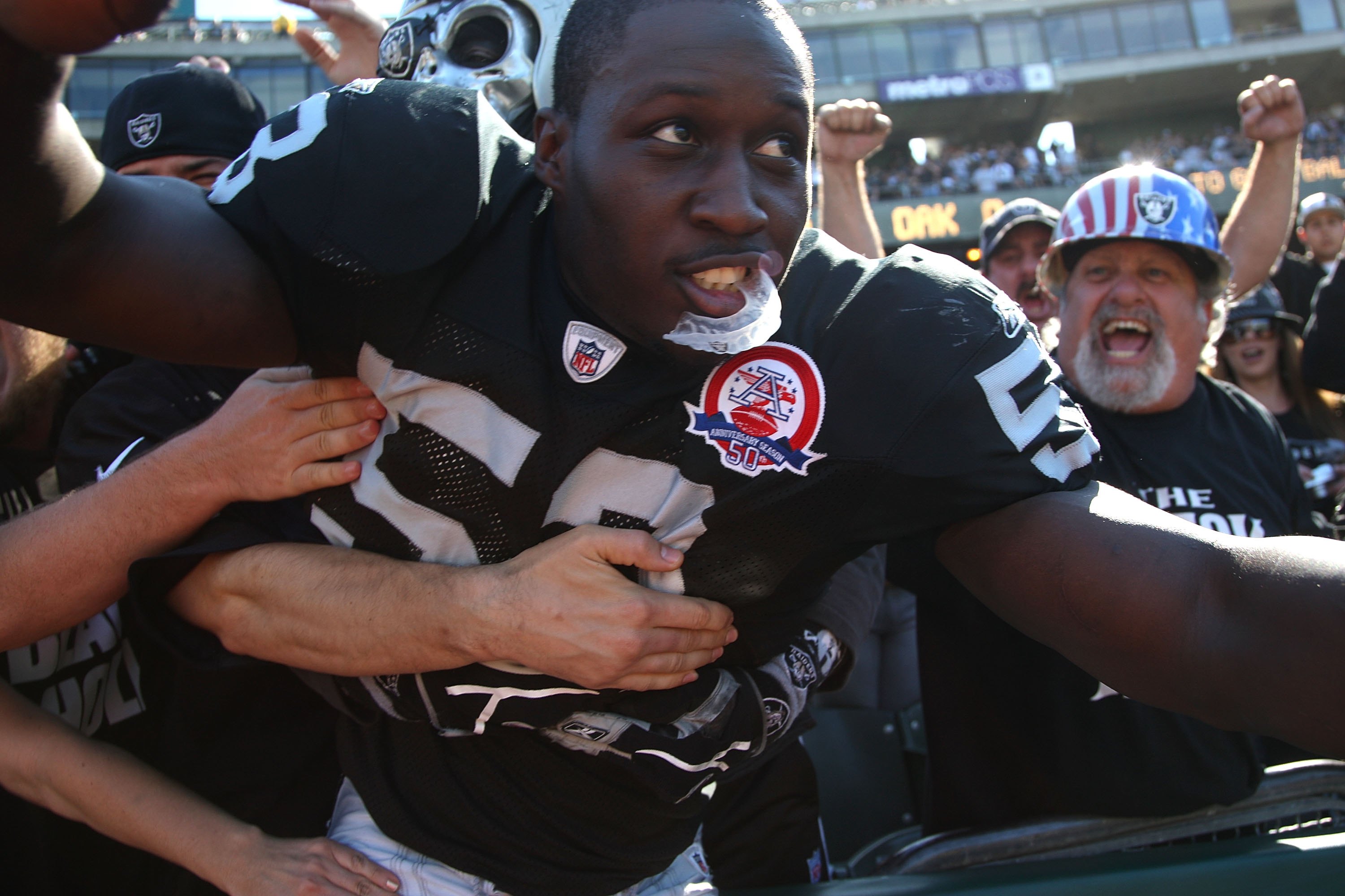 OAKLAND, CA - OCTOBER 25: Kirk Morrison #52 of the Oakland Raiders celebrates with fans against the New York Jets during an NFL game at the Oakland-Alameda County Coliseum on October 25, 2009 in Oakland, California. (Photo by Jed Jacobsohn/Getty Images)