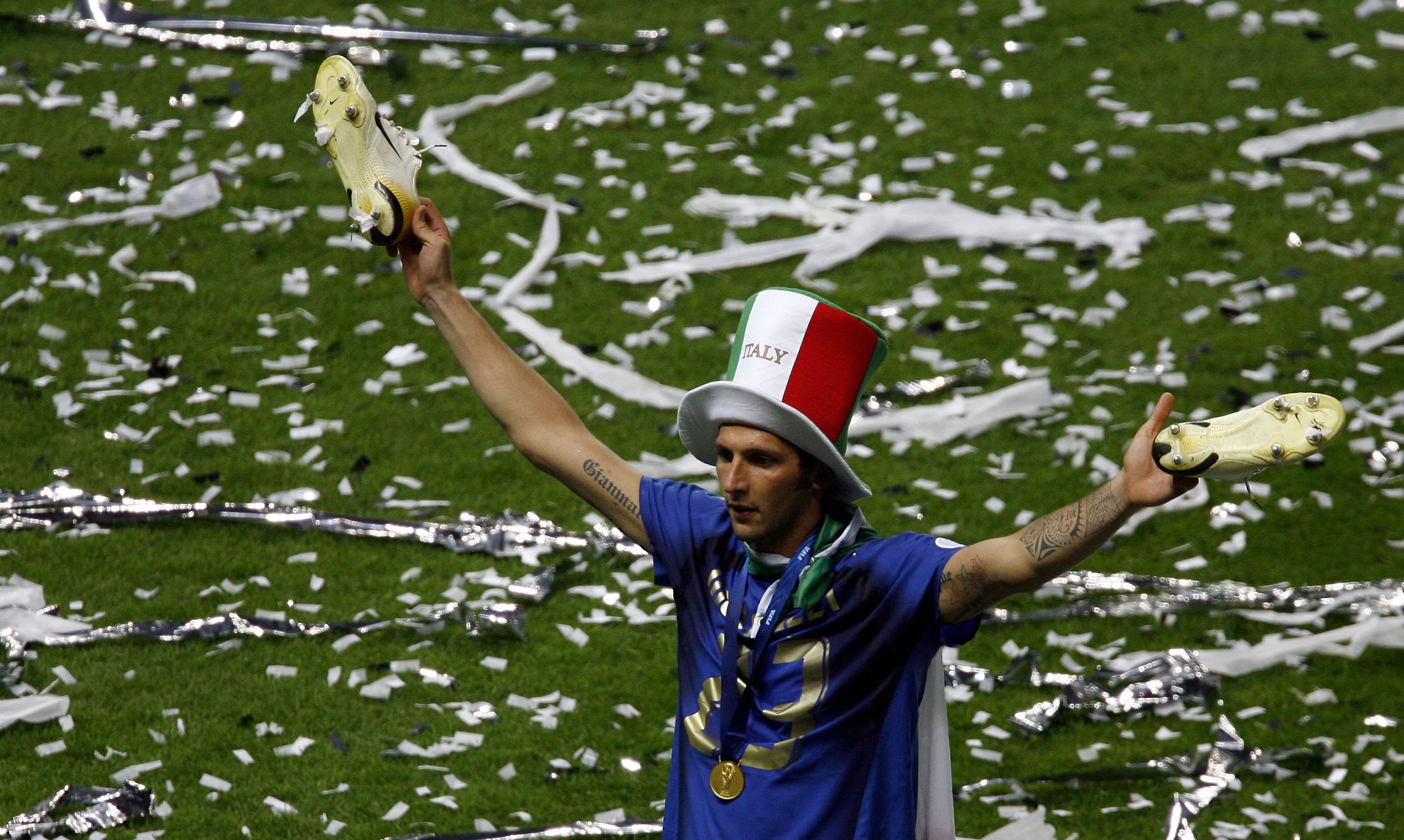 BERLIN - JULY 09:  Marco Materazzi of Italy holds his boots aloft following his team's victory in a penalty shootout at the end of the FIFA World Cup Germany 2006 Final match between Italy and France at the Olympic Stadium on July 9, 2006 in Berlin, Germa