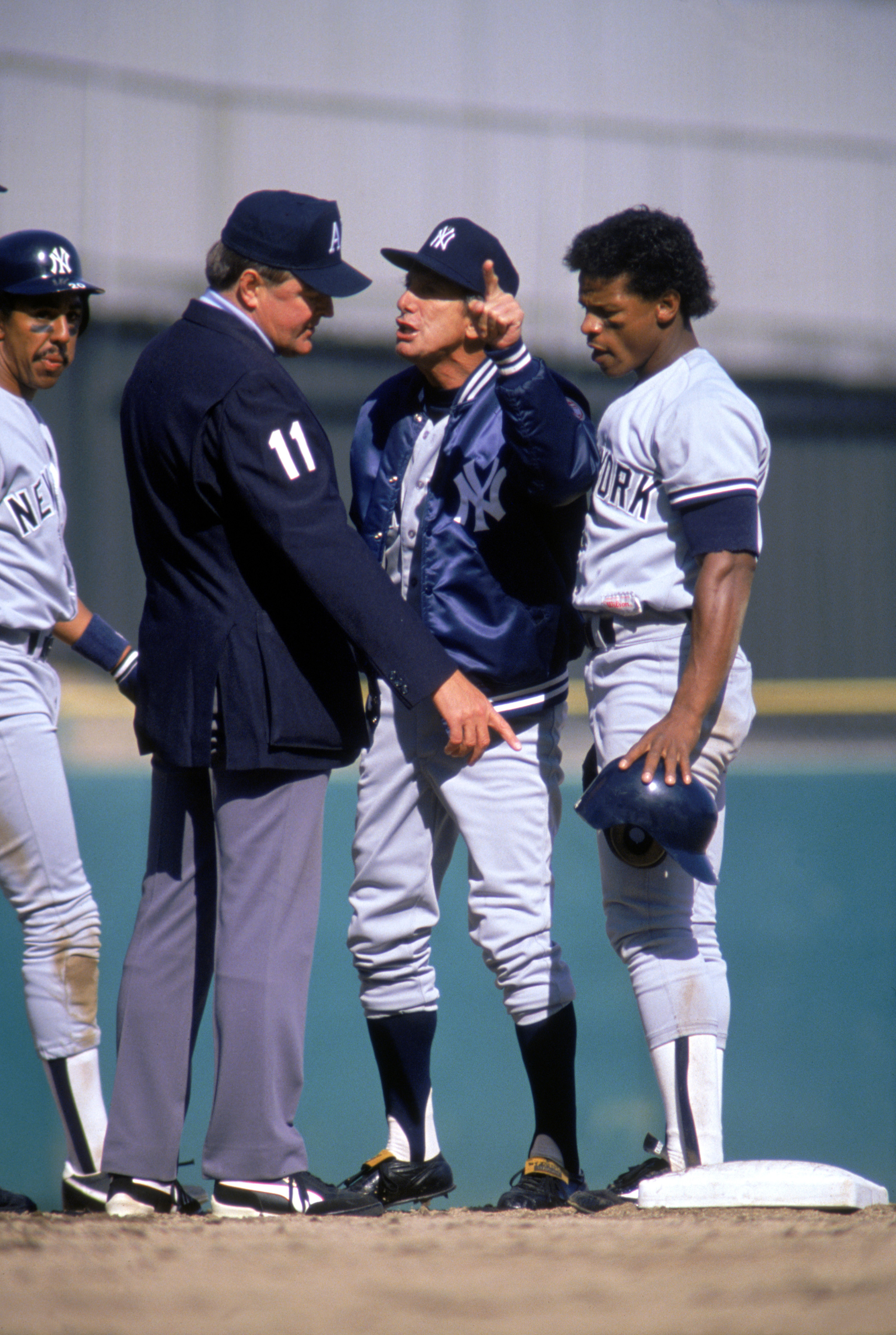 BRONX, NEW YORK - APRIL 7:  Manager Billy Martin of the New York Yankees argues with an umpire as outfielder Rickey Henderson #24 watches during the game on April 7, 1988 at Yankee Stadium in Bronx, New York. (Photo by Jonathan Daniel/Getty Images)