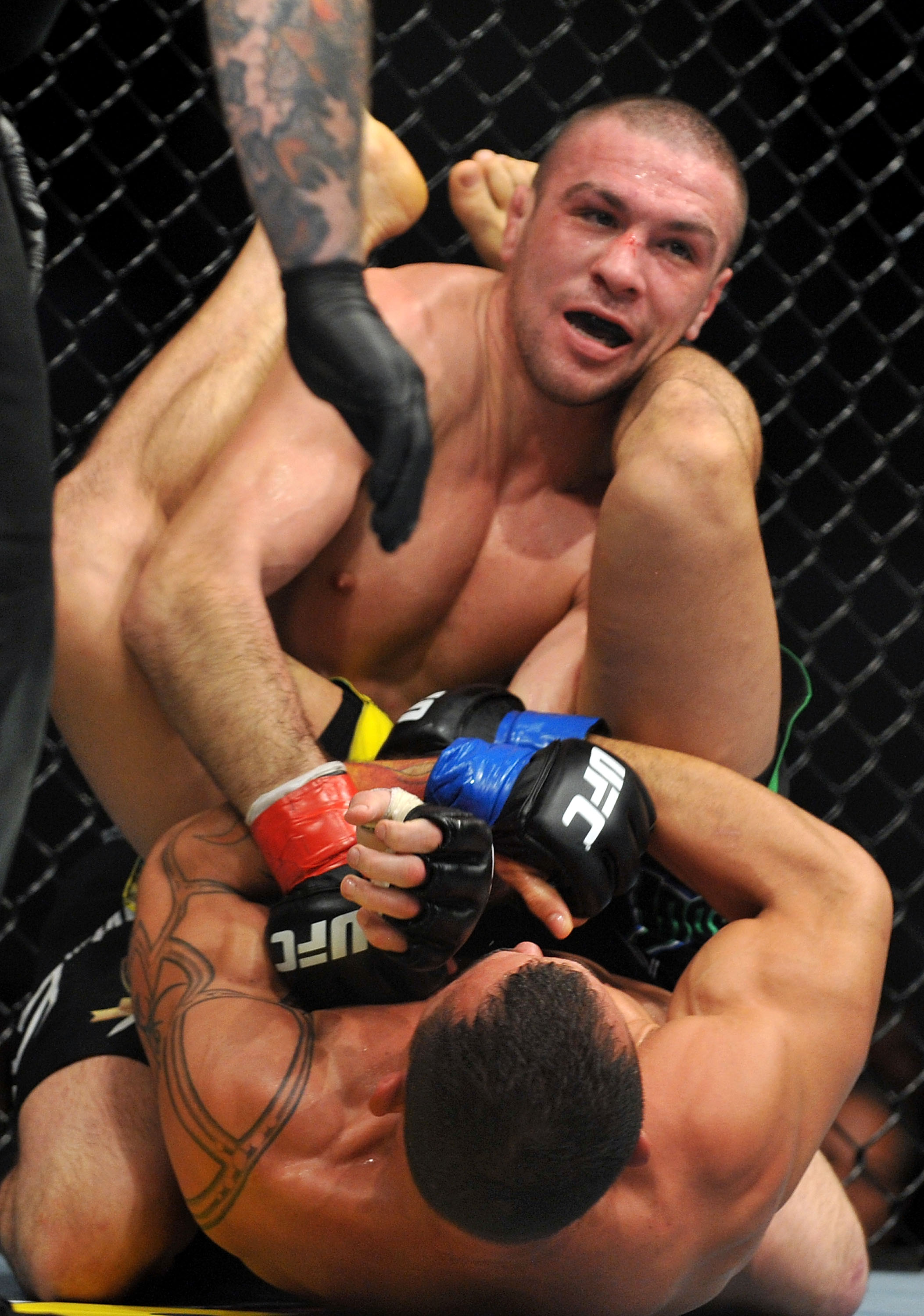 LOS ANGELES, CA - OCTOBER 24:  UFC fighter Gleison Tibau (top) battles with UFC fighter Josh Neer (top) during their Lightweight 'Swing' bout at UFC 104: Machida vs. Shogun at Staples Center on October 24, 2009 in Los Angeles, California.  (Photo by Jon K