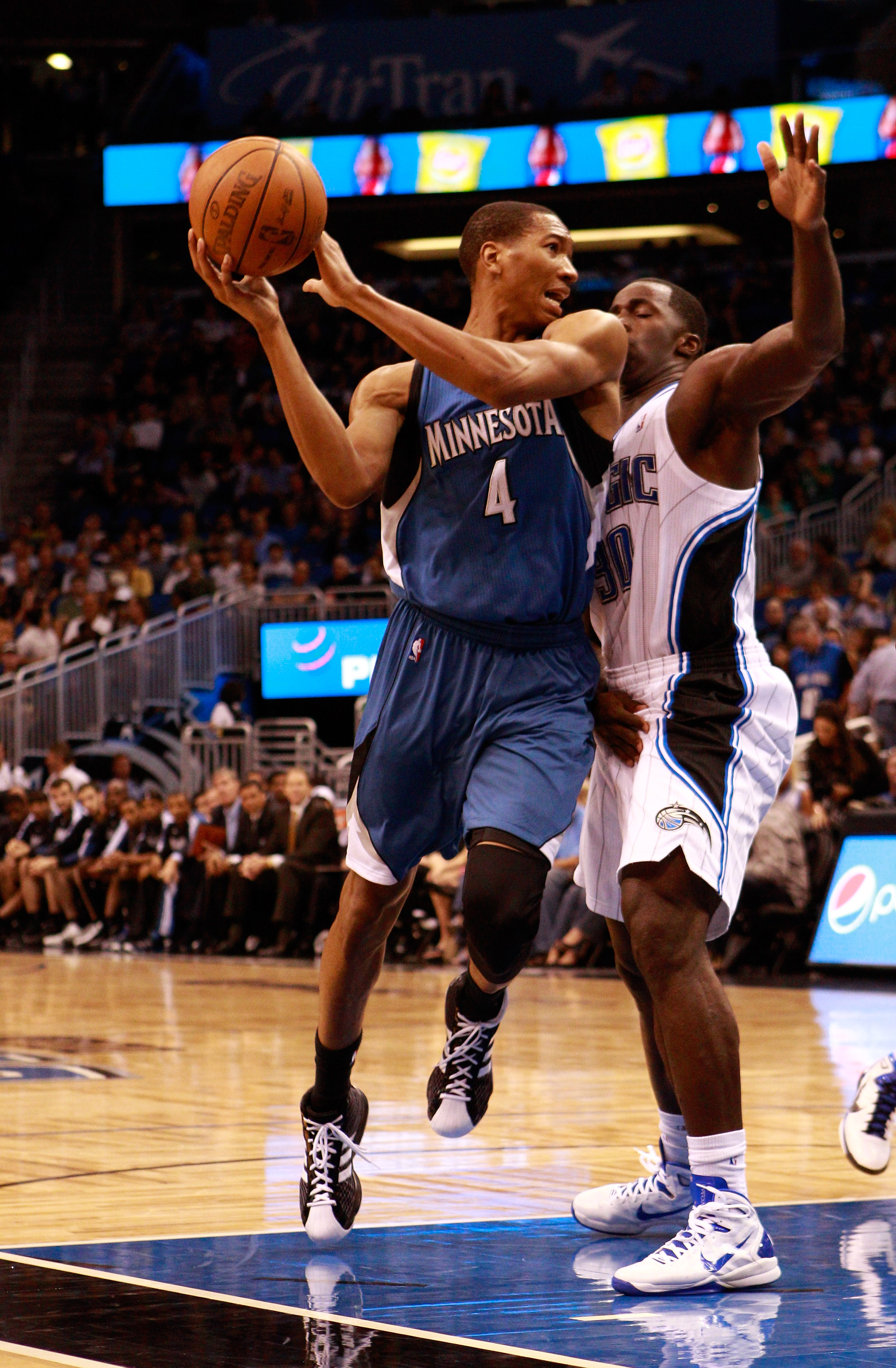 ORLANDO, FL - NOVEMBER 03:  Wesley Johnson #4 of the Minnesota Timberwolves attempts to pass against Brandon Bass #30 of the Orlando Magic during the game at Amway Arena on November 3, 2010 in Orlando, Florida.  NOTE TO USER: User expressly acknowledges a