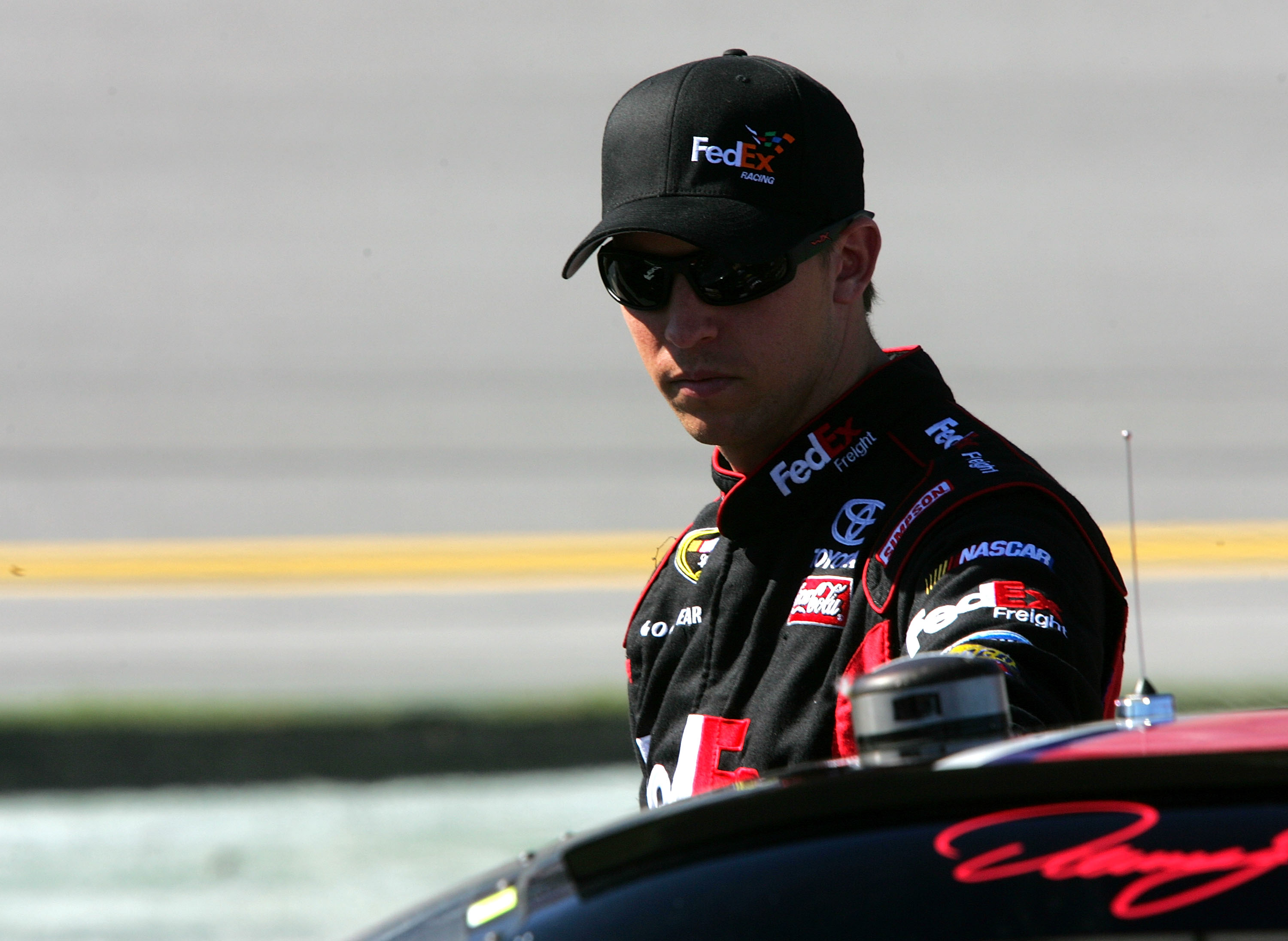 TALLADEGA, AL - OCTOBER 30:  Denny Hamlin, driver of the #11 FedEx Freight Toyota, walks on pit road during qualifying for the NASCAR Sprint Cup Series AMP Energy Juice 500 at Talladega Superspeedway on October 30, 2010 in Talladega, Alabama.  (Photo by J