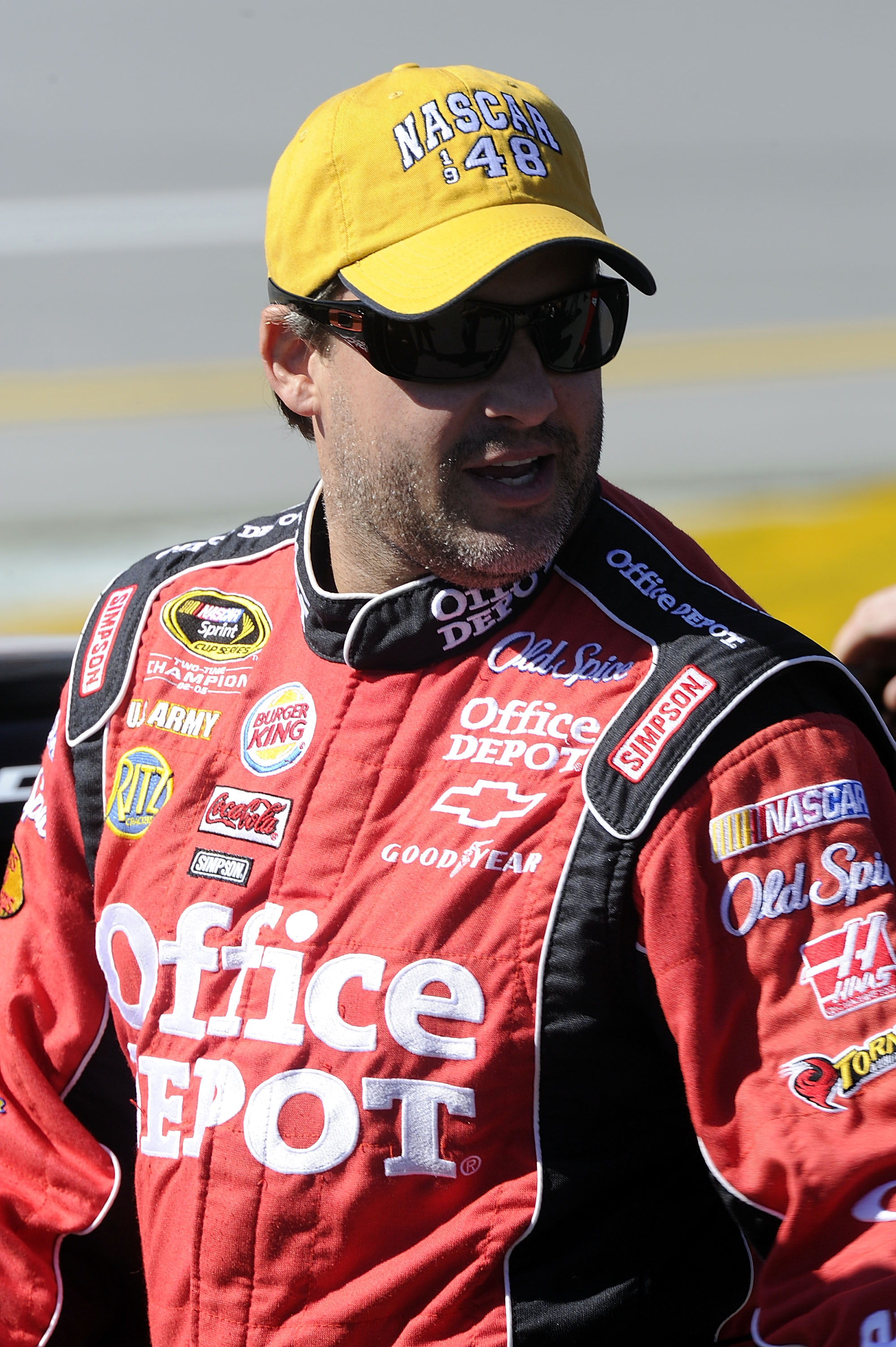 TALLADEGA, AL - OCTOBER 30:  Tony Stewart, driver of the #14 Old Spice/Office Depot Chevrolet, walks on the grid during qualifying for the NASCAR Sprint Cup Series AMP Energy Juice 500 at Talladega Superspeedway on October 30, 2010 in Talladega, Alabama.