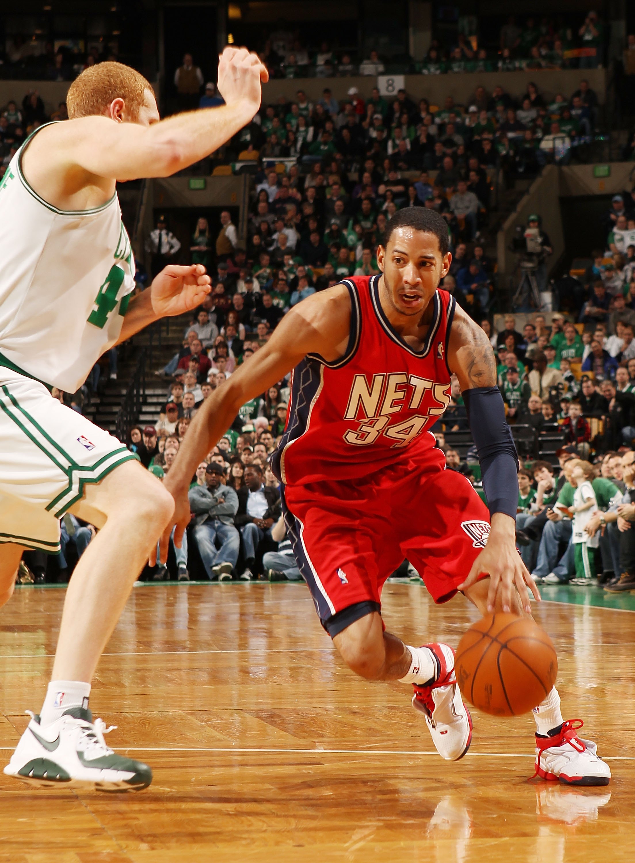 BOSTON - FEBRUARY 27:  Devin Harris #34 of the New Jersey Nets drives to the net as Brian Scalabrine #44 of the Boston Celtics defends at the TD Garden on February 27, 2010 in Boston, Massachusetts. The Nets defeated the Celtics 104-96.  NOTE TO USER: Use