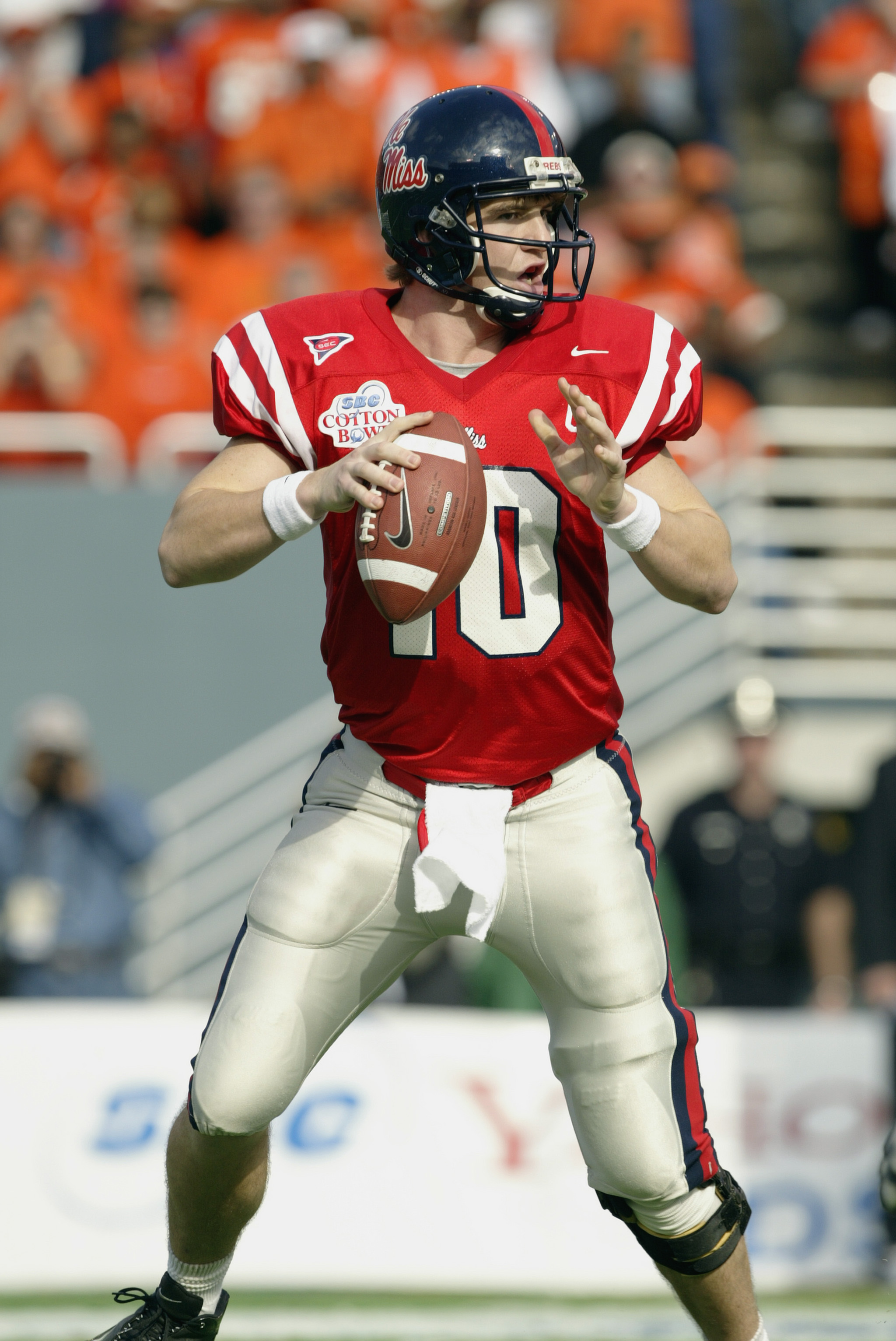 DALLAS - JANUARY 2:  Quarterback Eli Manning #10 of the Mississippi Rebels looks for the open receiver during the SBC Cotton Bowl against the Oklahoma State Cowboys on January 2, 2004 at the Cotton Bowl in Dallas, Texas.  'Ole Miss defeated Oklahoma State