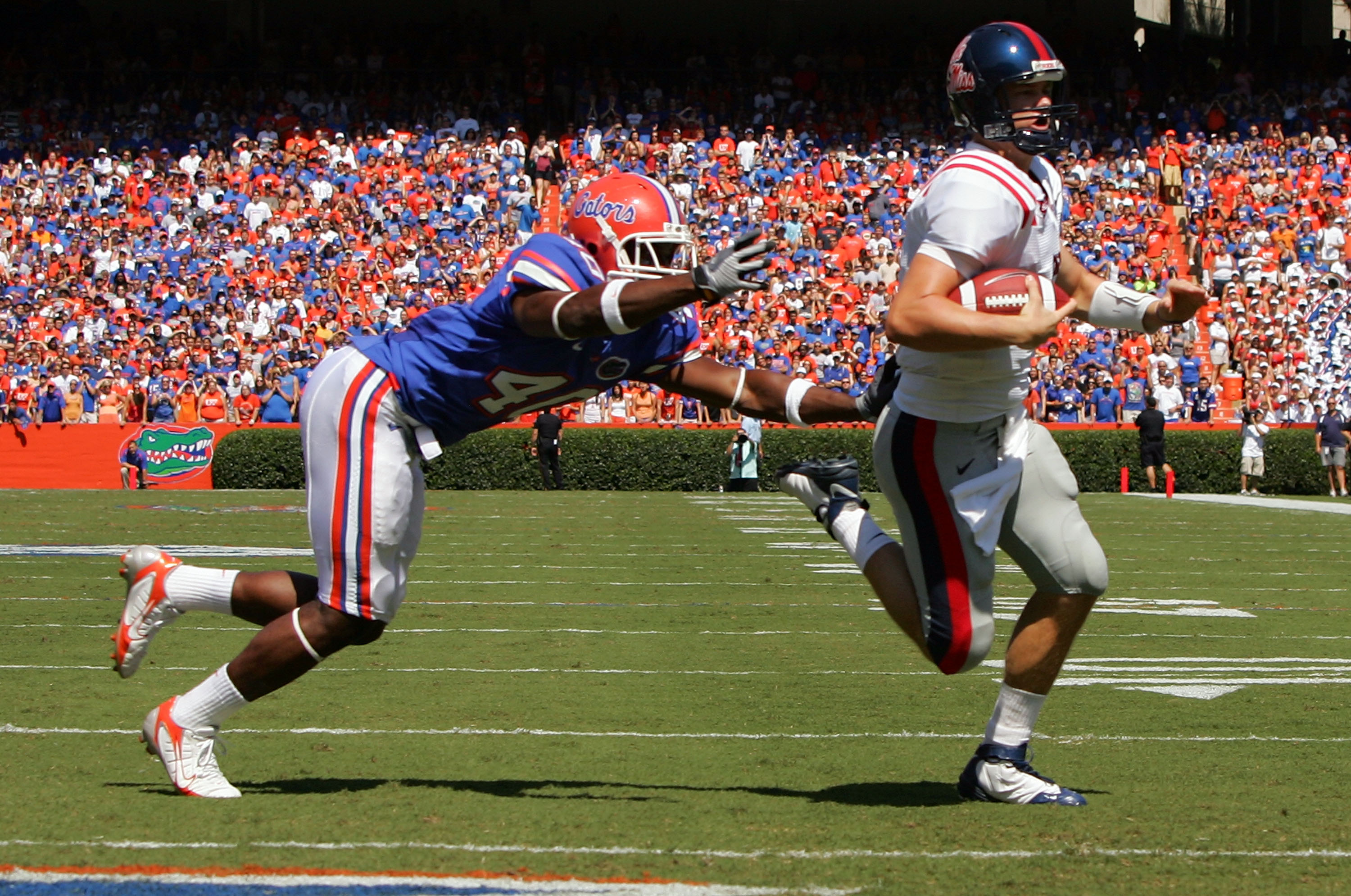 GAINESVILLE, FL - SEPTEMBER 27:  Quarterback Jevan Snead #4 of the Ole Miss Rebels runs for a touchdown against Brnadon Hicks #40 of the Florida Gators during the game at Ben Hill Griffin Stadium on September 27, 2008 in Gainesville, Florida.  (Photo by S