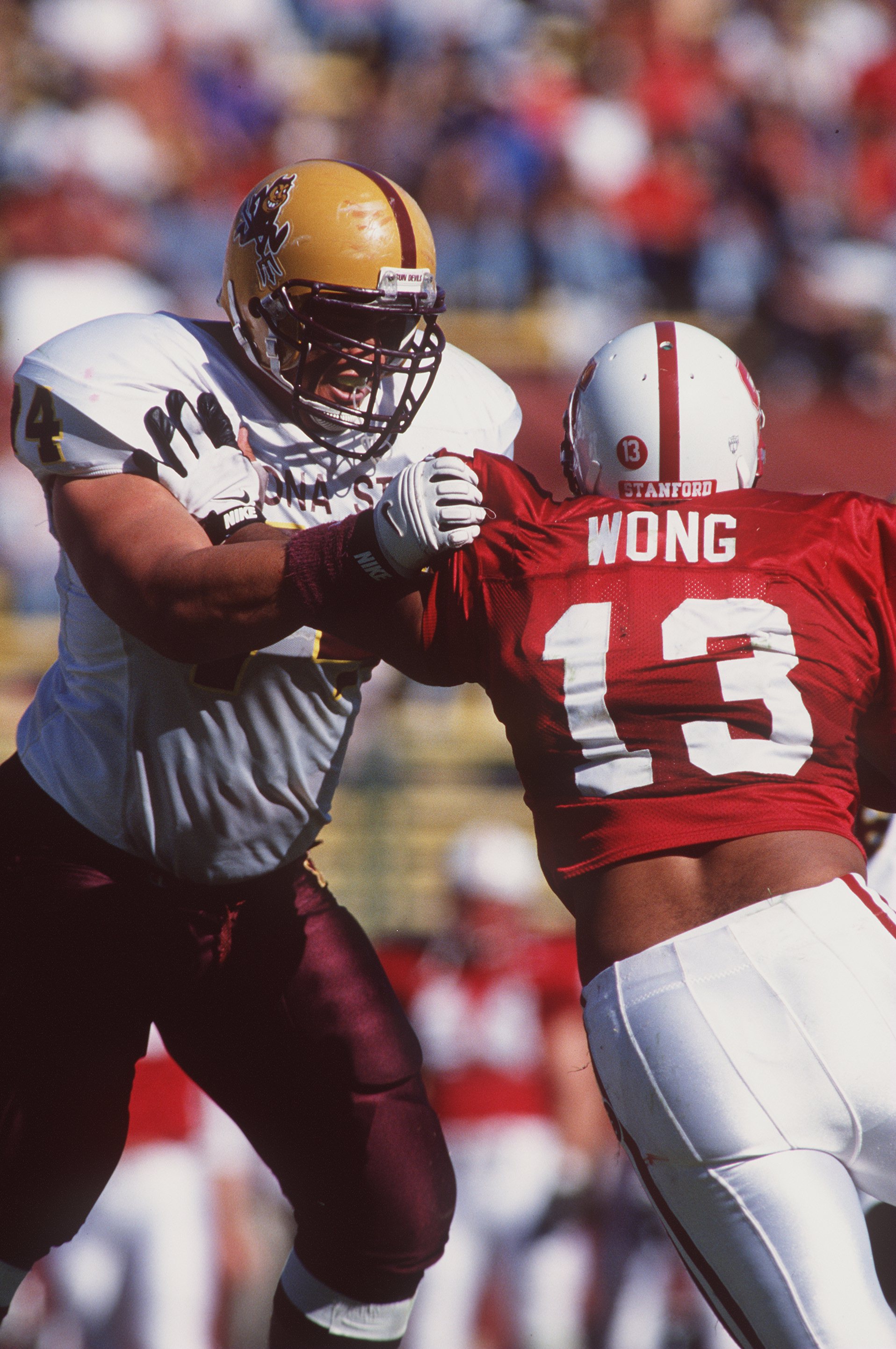 26 Oct 1996:  Offensive lineman Juan Roque of the Arizona State Sun Devils engages his opponent Kailee Wong #13 of the Stanford Cardinal during a pass play in the Sun Devils 41-9 victory over the Cardinal at Stanford Stadium in Palo Alto, California.