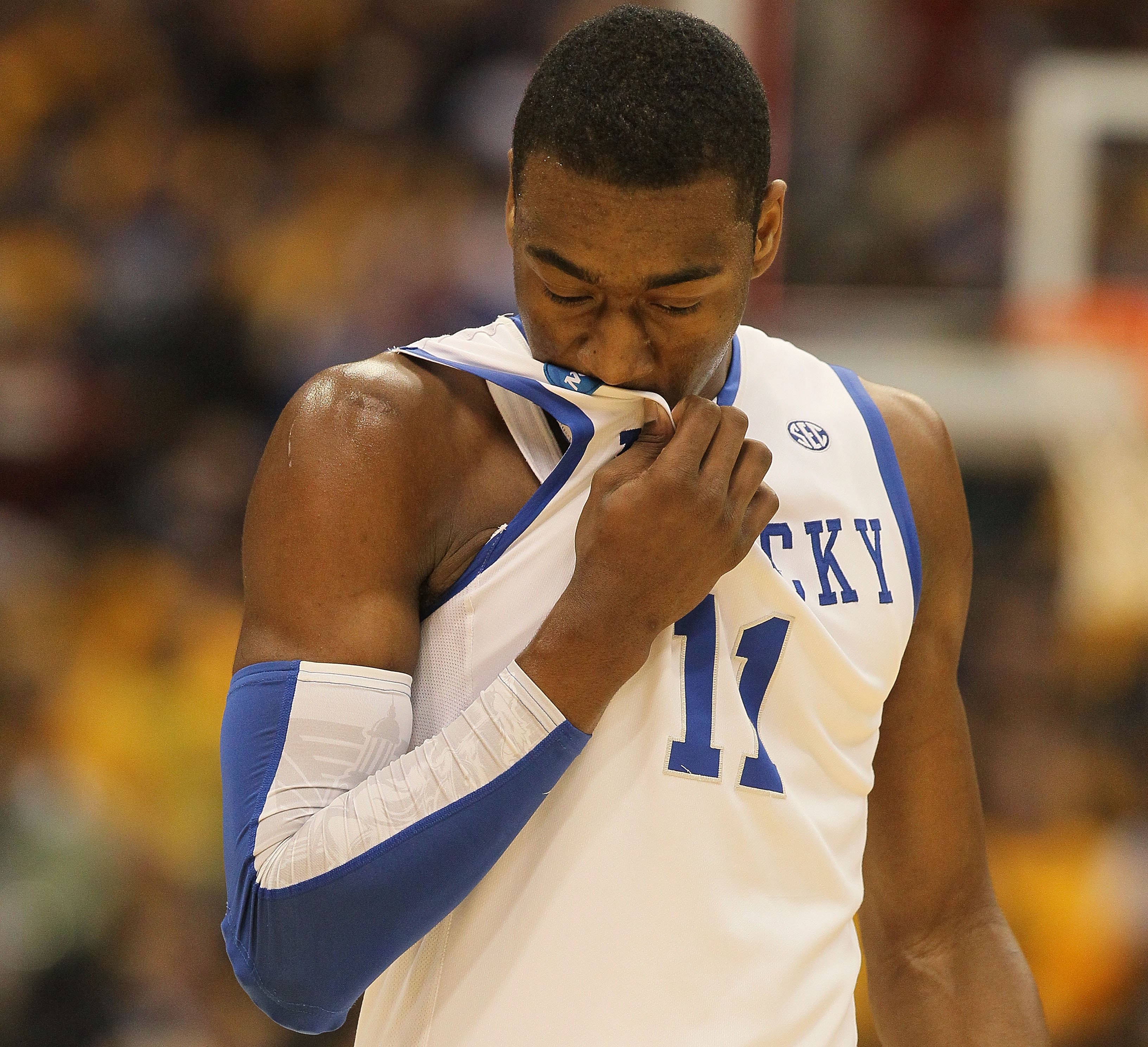 SYRACUSE, NY - MARCH 27:  John Wall #11 of the Kentucky Wildcats wipes his face with his jersey against the West Virginia Mountaineers during the east regional final of the 2010 NCAA men's basketball tournament at the Carrier Dome on March 27, 2010 in Syr