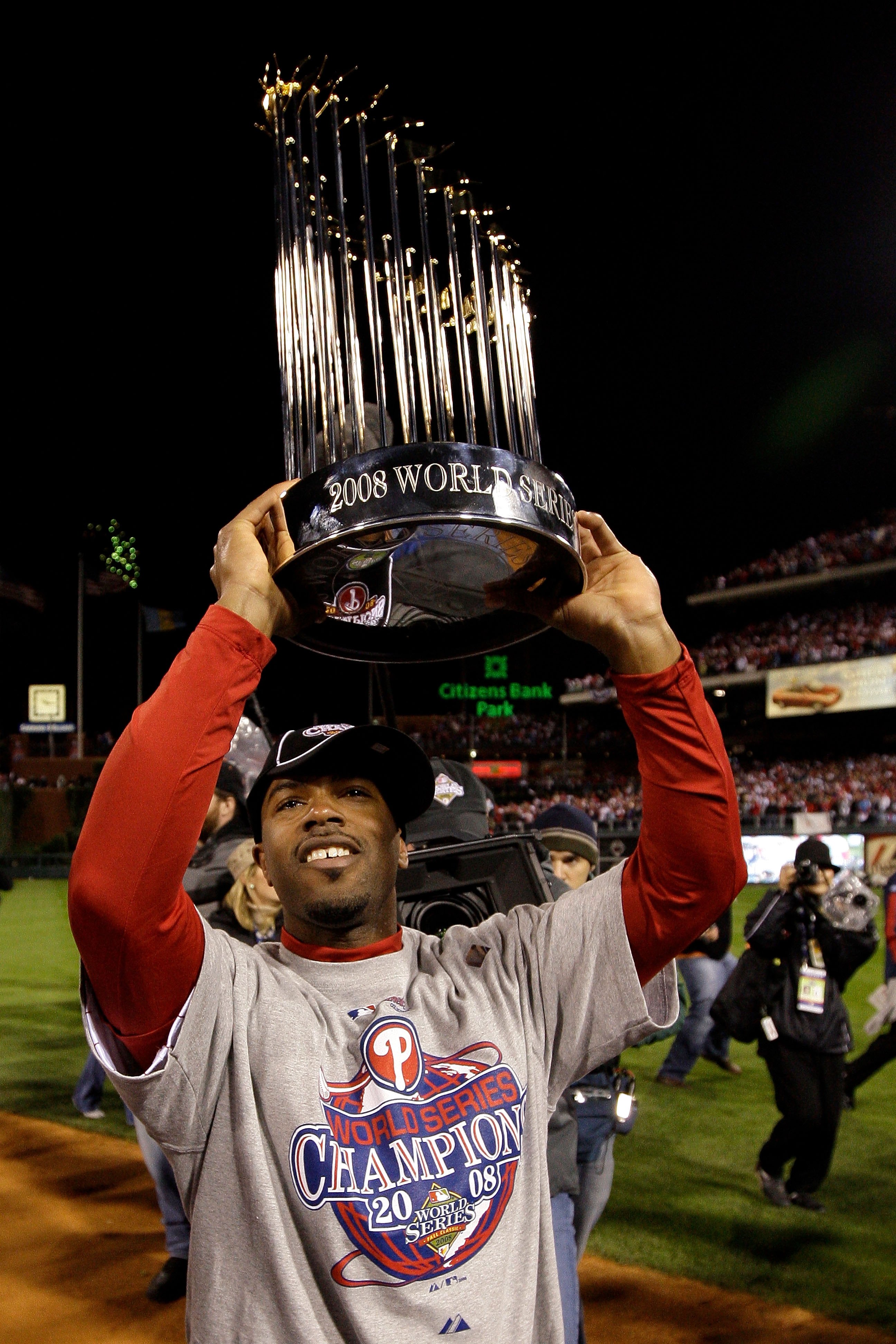 PHILADELPHIA - OCTOBER 29:  Jimmy Rollins #11 of the Philadelphia Phillies celebrates with the World Series Championship trophy after their 4-3 win against the Tampa Bay Rays during the continuation of game five of the 2008 MLB World Series on October 29,