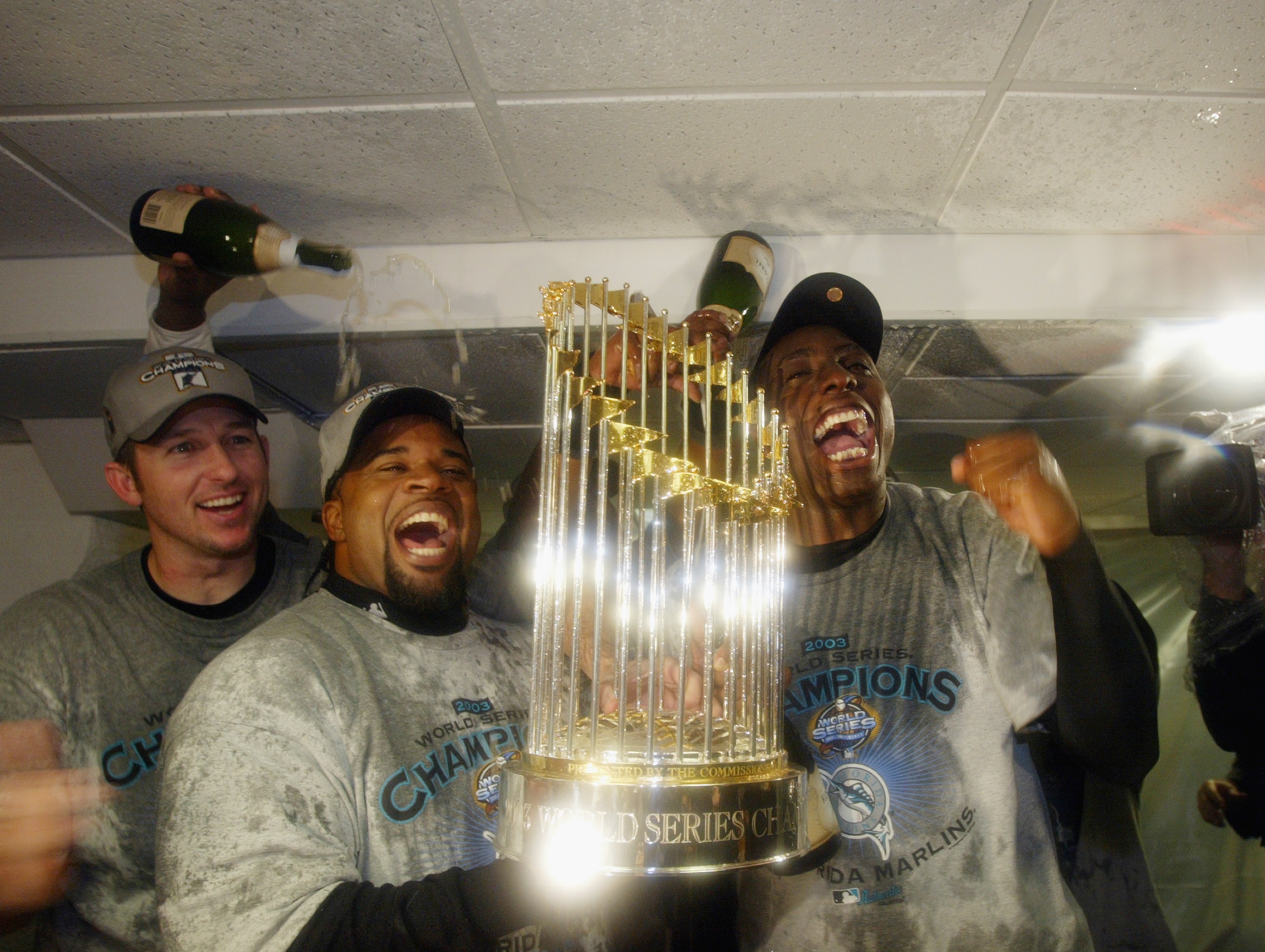 BRONX, NY - OCTOBER 25: Florida Marlins players celebrate with the World Series Trophy after defeating the New York Yankees in game six of the Major League Baseball World Series on October 25, 2003 at Yankee Stadium in the Bronx, New York. The Marlins w