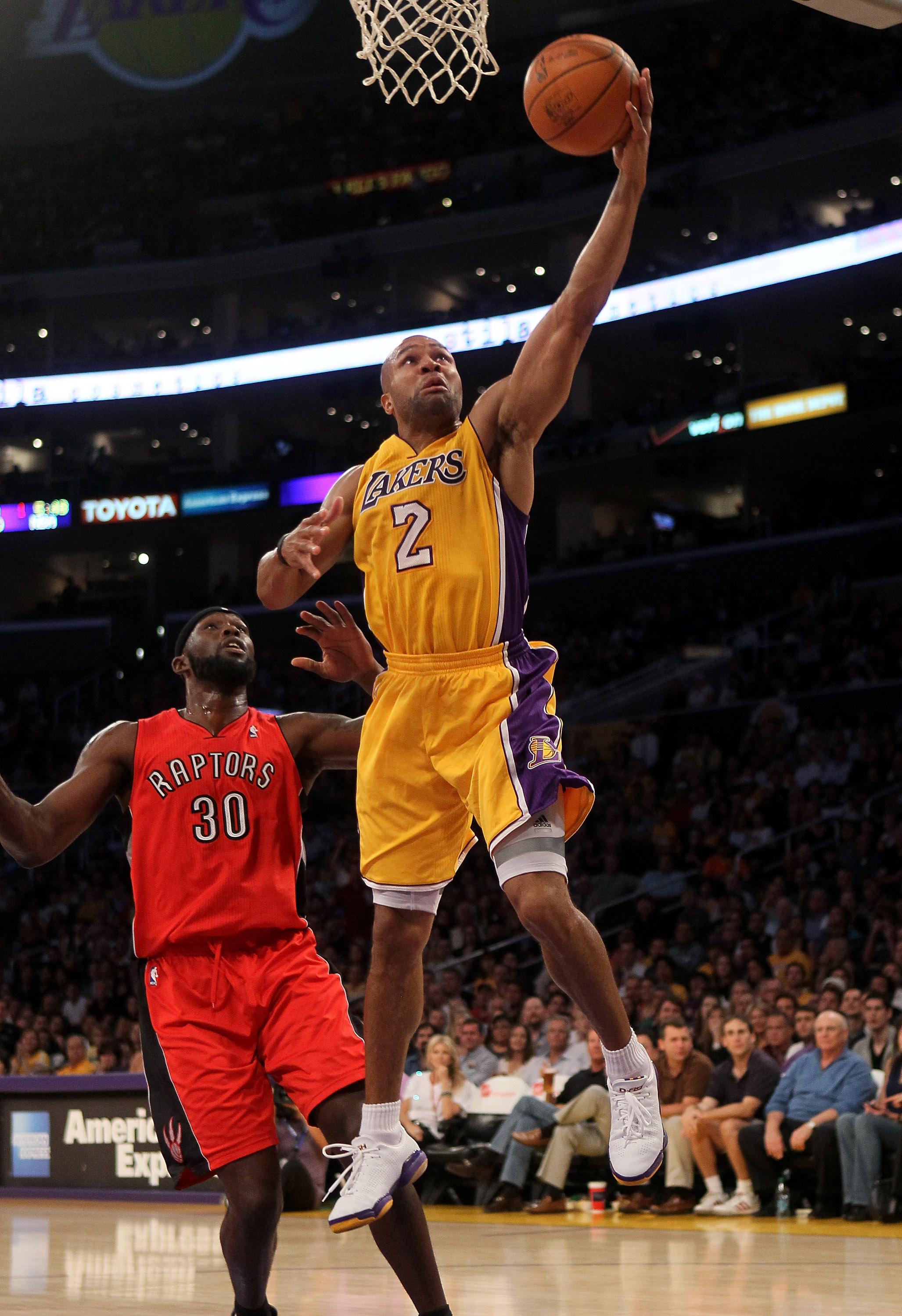 LOS ANGELES, CA - NOVEMBER 05: Derek Fisher #2  of the Los Angeles Lakers shoots over Reggie Evans #30 of the Toronto Raptors at Staples Center on November 5, 2010 in Los Angeles, California.   NOTE TO USER: User expressly acknowledges and agrees that, by