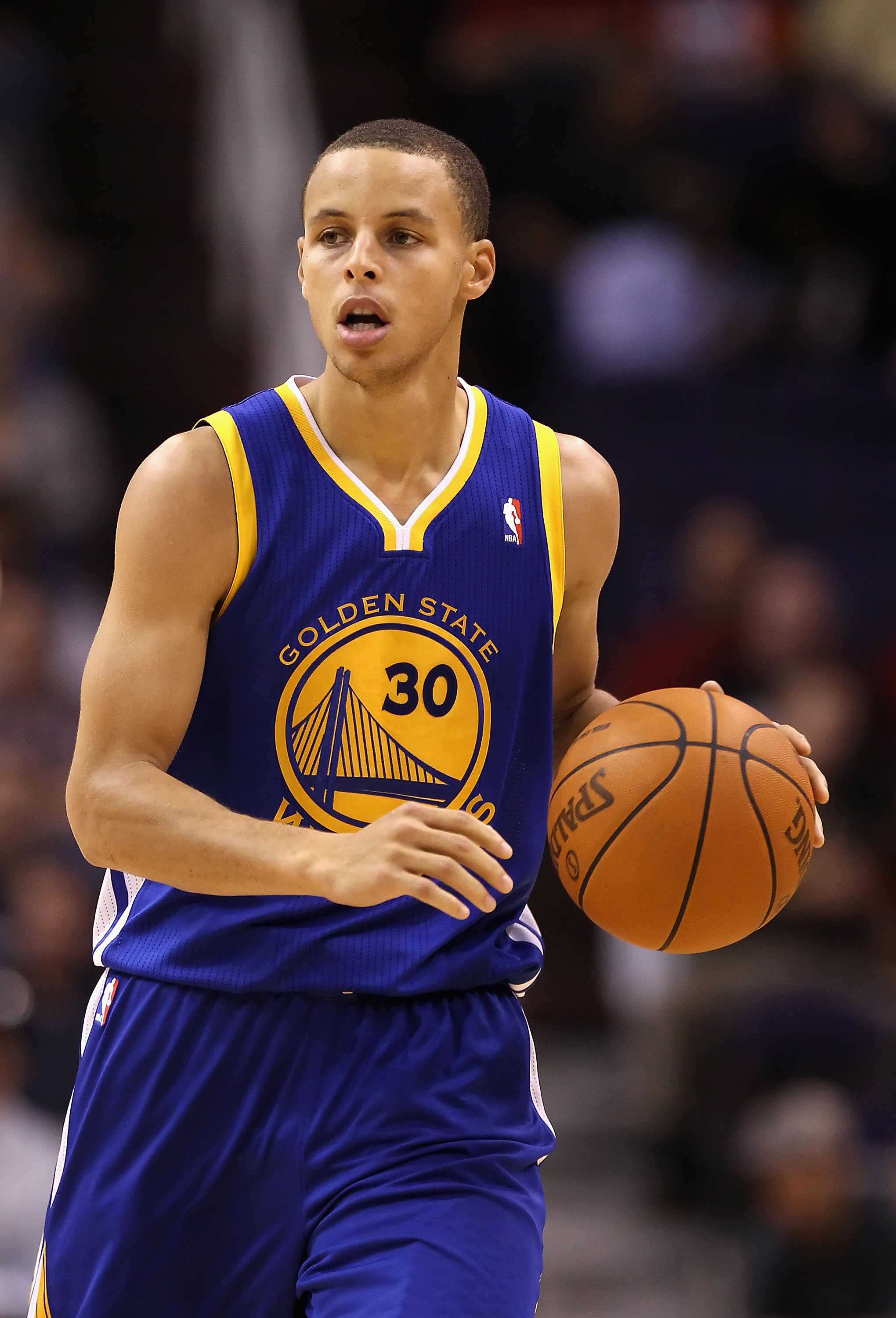 PHOENIX - OCTOBER 19:  Stephen Curry #30 of the Golden State Warriors handles the ball during the preseason NBA game against the Phoenix Suns at US Airways Center on October 19, 2010 in Phoenix, Arizona. NOTE TO USER: User expressly acknowledges and agree