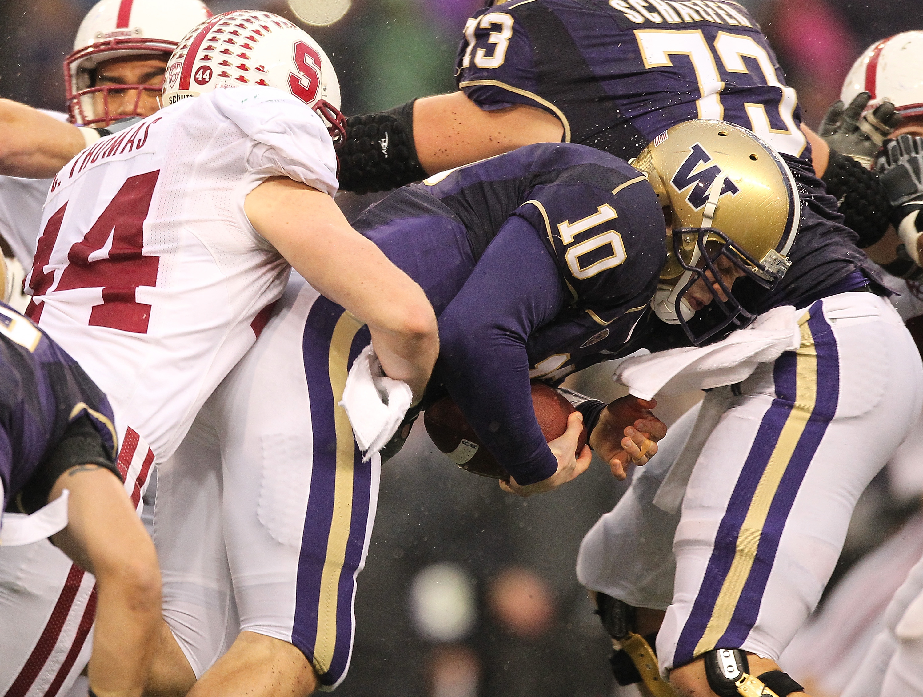 SEATTLE - OCTOBER 30: Quarterback Jake Locker #10 of the Washington Huskies is tackled by Chase Thomas #44 of the Stanford Cardinal on October 30, 2010 at Husky Stadium in Seattle, Washington. (Photo by Otto Greule Jr/Getty Images)