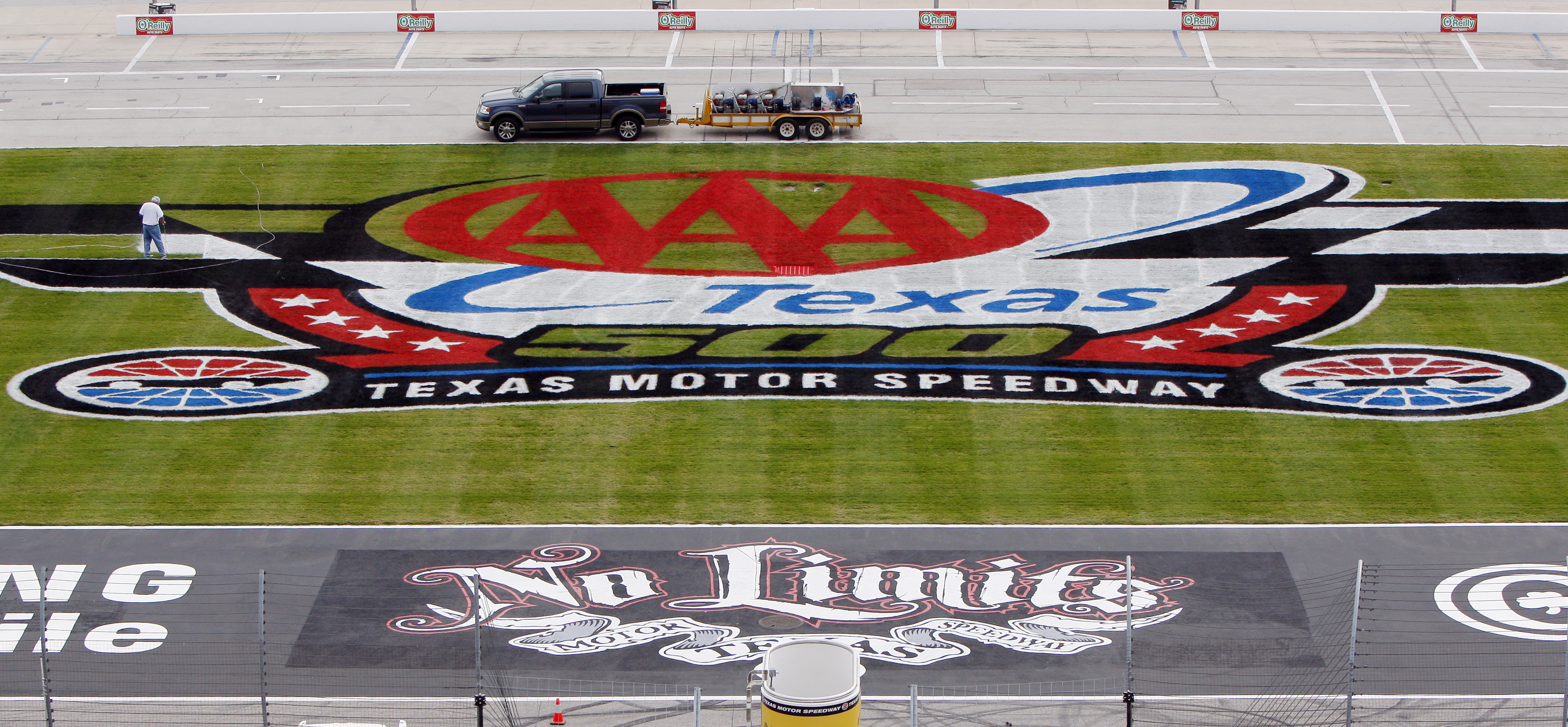 FORT WORTH, TX - NOVEMBER 1: Steve Boudrow  paints the 'AAA Texas 500 logo' on the infield grass at Texas Motor Speedway on November 1, 2010 in Fort Worth, Texas. (Brandon Wade/Getty Images for Texas Motor Speedway)