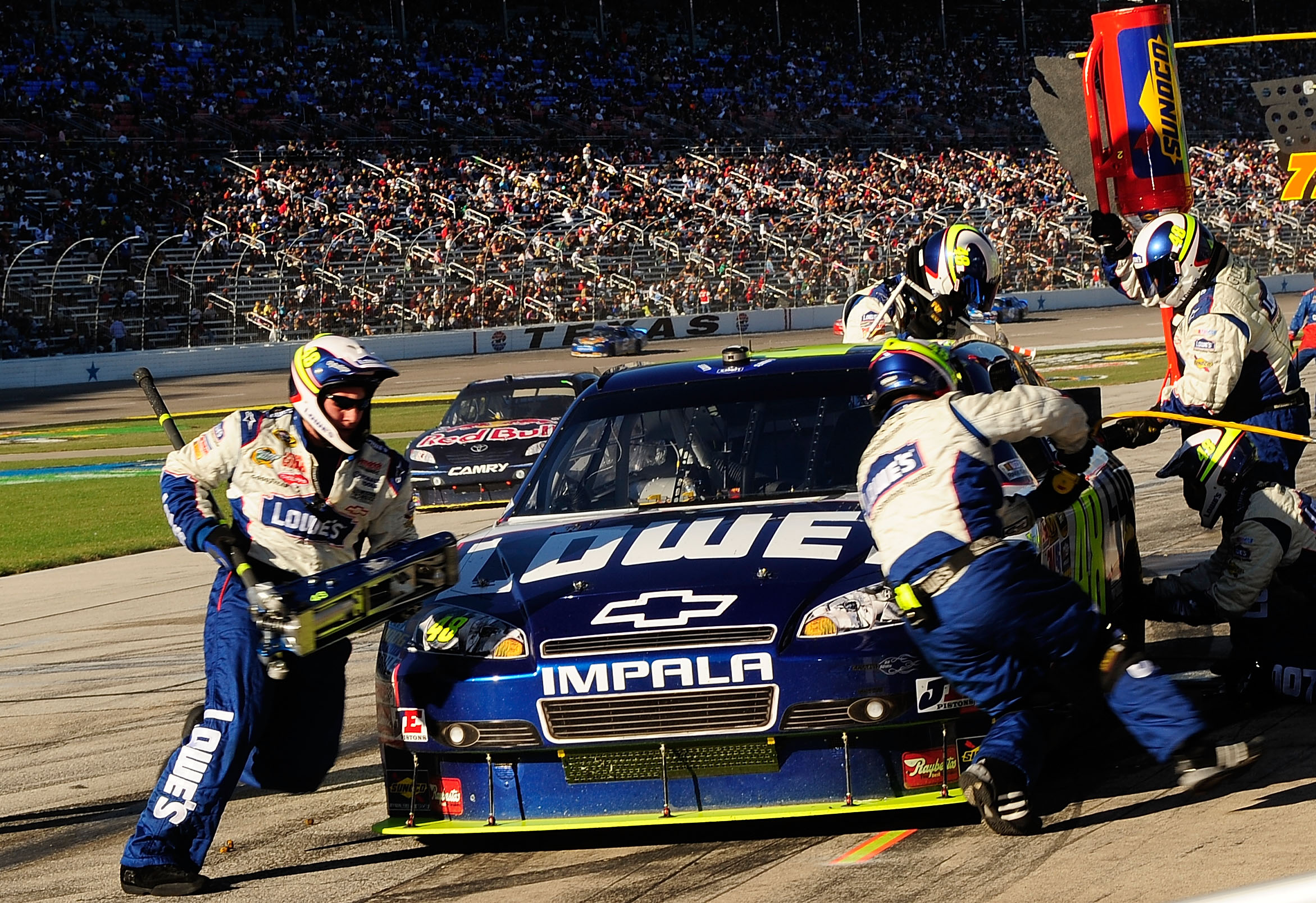 FORT WORTH, TX - NOVEMBER 07:  Jimmie Johnson, driver of the #48 Lowe's Chevrolet, makes a pit stop during the NASCAR Sprint Cup Series AAA Texas 500 at Texas Motor Speedway on November 7, 2010 in Fort Worth, Texas.  (Photo by Rusty Jarrett/Getty Images f