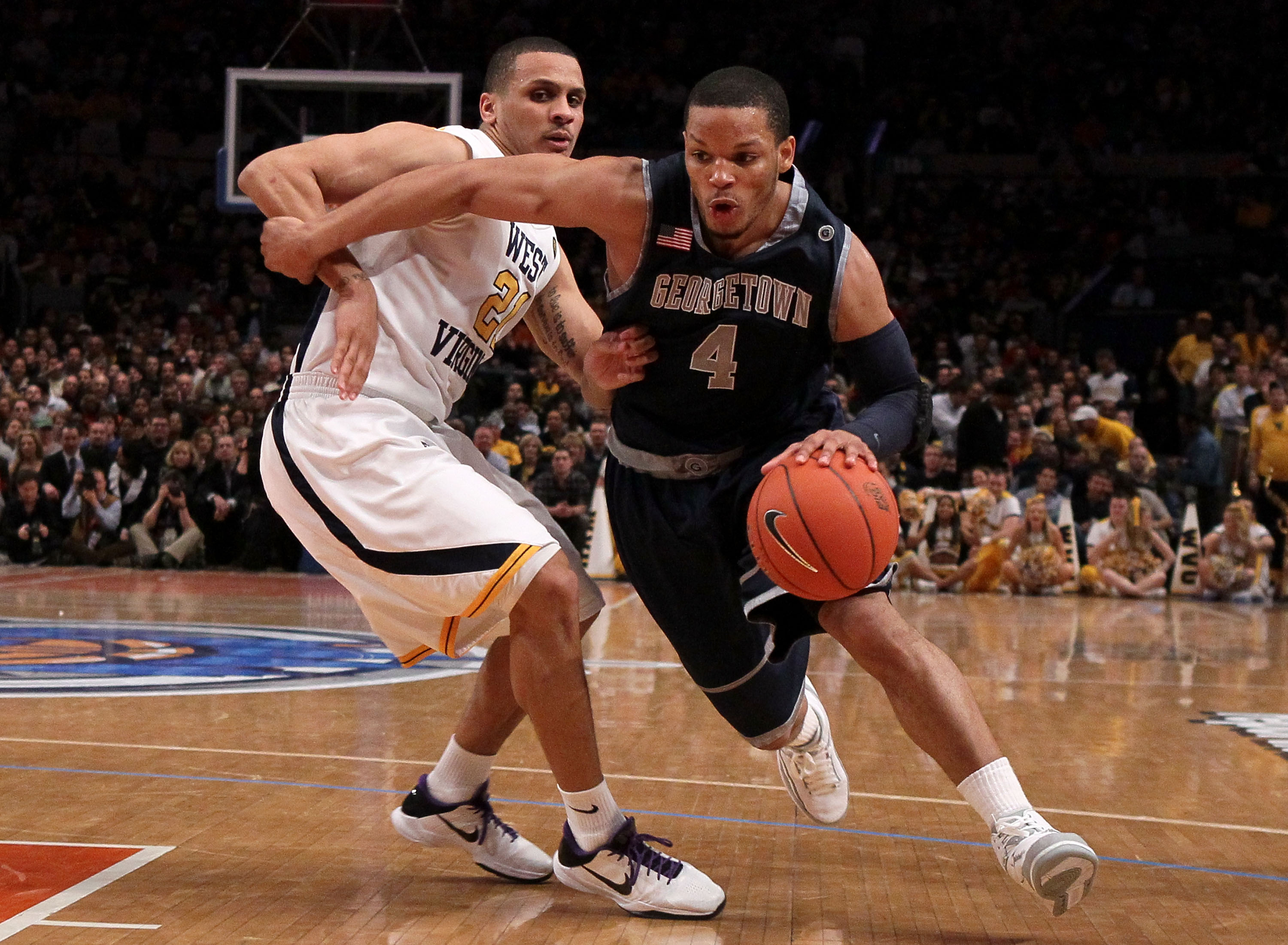 NEW YORK - MARCH 13: Chris Wright #4 of the Georgetown Hoyas handles the ball against Joe Mazzulla #21 of the West Virginia Mountaineers during the championship of the 2010 NCAA Big East Tournament at Madison Square Garden on March 13, 2010 in New York C