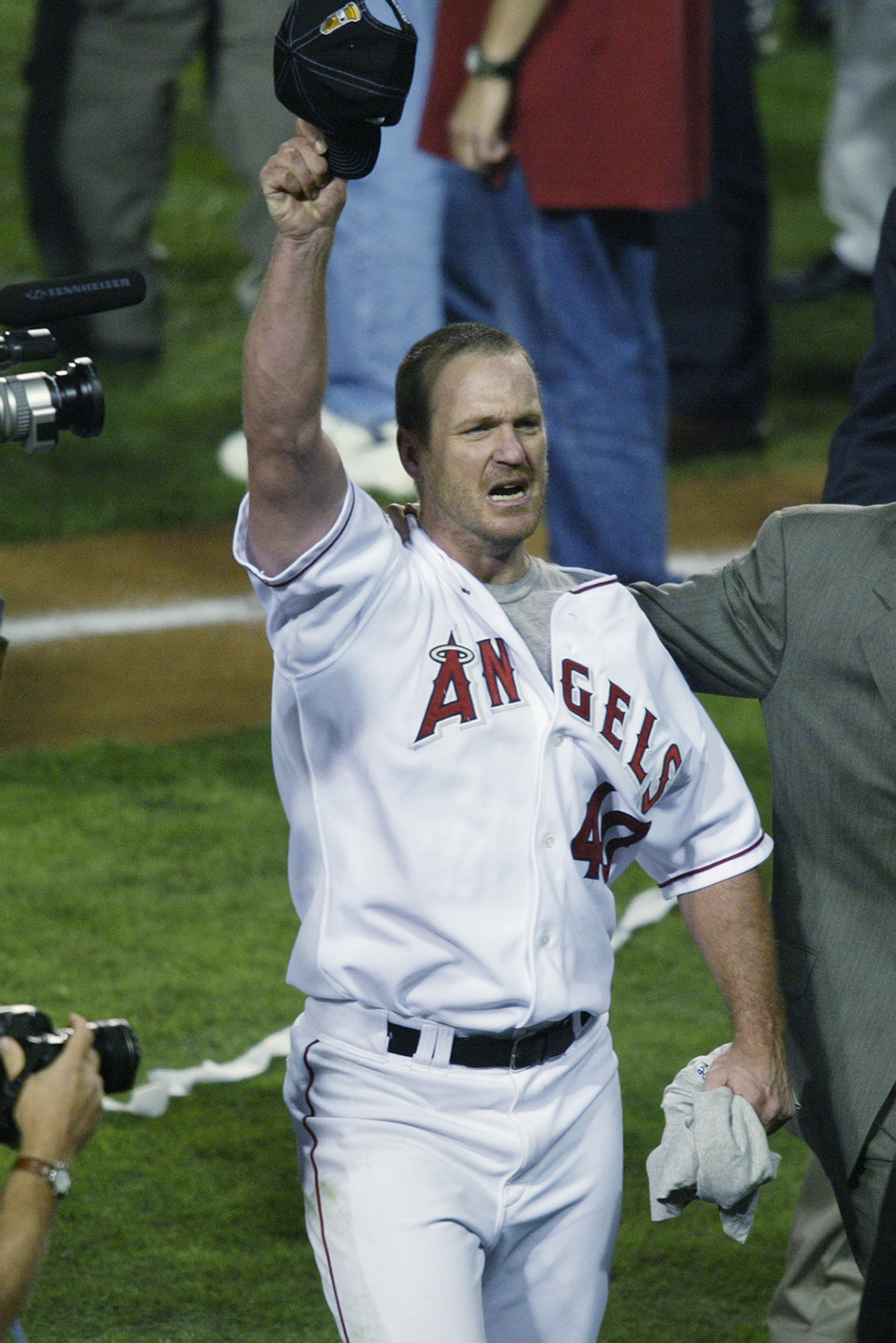 ANAHEIM, CA - OCTOBER 27:  Troy Percival #40 of the Anaheim Angels salutes the crowd after the victory over the San Francisco Giants as he is led to an interview after game seven of the World Series on October 27, 2002 at Edison Field in Anaheim, Californ