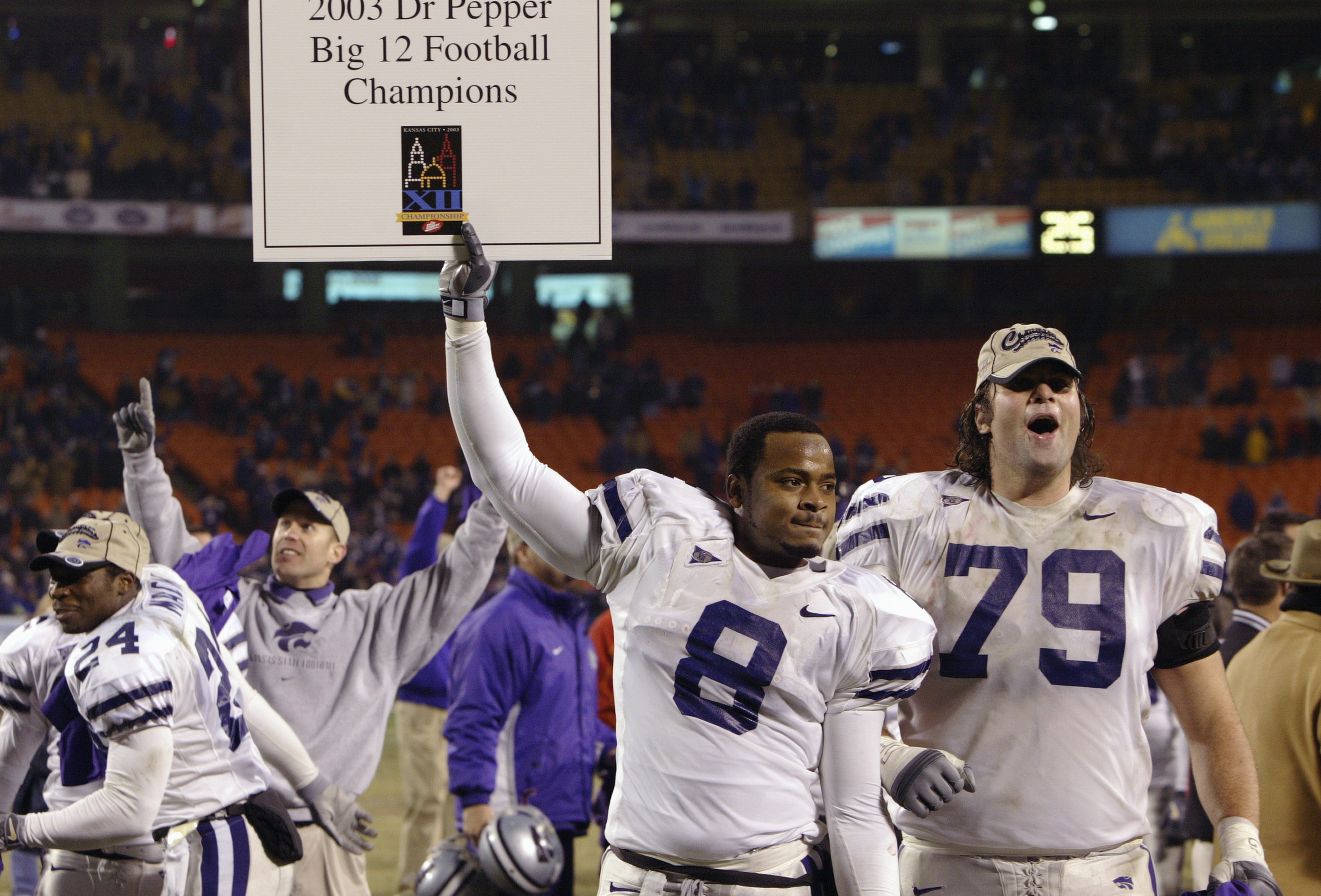 KANSAS CITY, MO - DECEMBER 6:  Defensive back James McGill #8 and tackle Jon Doty #79 of the Kansas State Wildcats celebrate after defeating the Oklahoma Sooners in the Dr. Pepper Big 12 Championship on December 6, 2003 at Arrowhead Stadium in Kansas City
