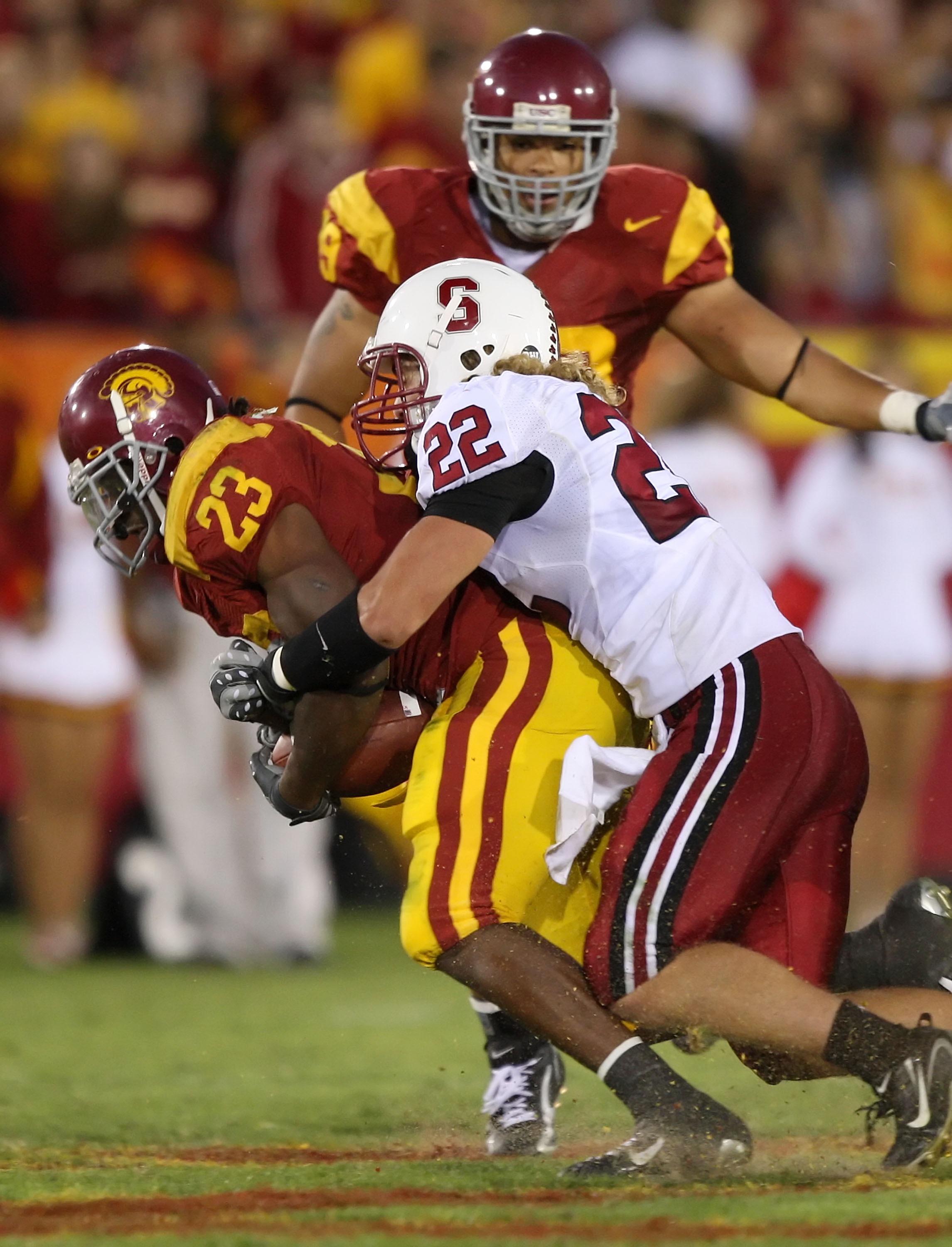 LOS ANGELES - OCTOBER 6:  Bo McNally #22 of the Stanford University Cardinal tackles Chauncey Washington #23 of the USC Trojans at the Los Angeles Memorial Coliseum October 6, 2007 in Los Angeles, California.  (Photo by Lisa Blumenfeld/Getty Images)