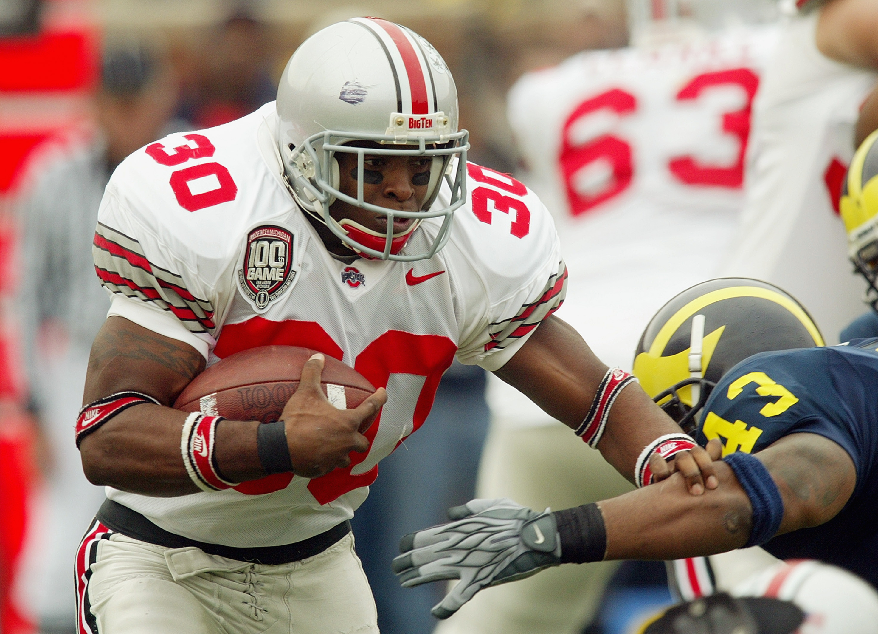 ANN ARBOR, MI - NOVEMBER 22:  Running back Lydell Ross #30 of the Ohio State Buckeyes runs the football as linebacker Carl Diggs #43 of the Michigan Wolverines in the 100th meeting of the two teams November 22, 2003 at Michigan Stadium in Ann Arbor, Michi