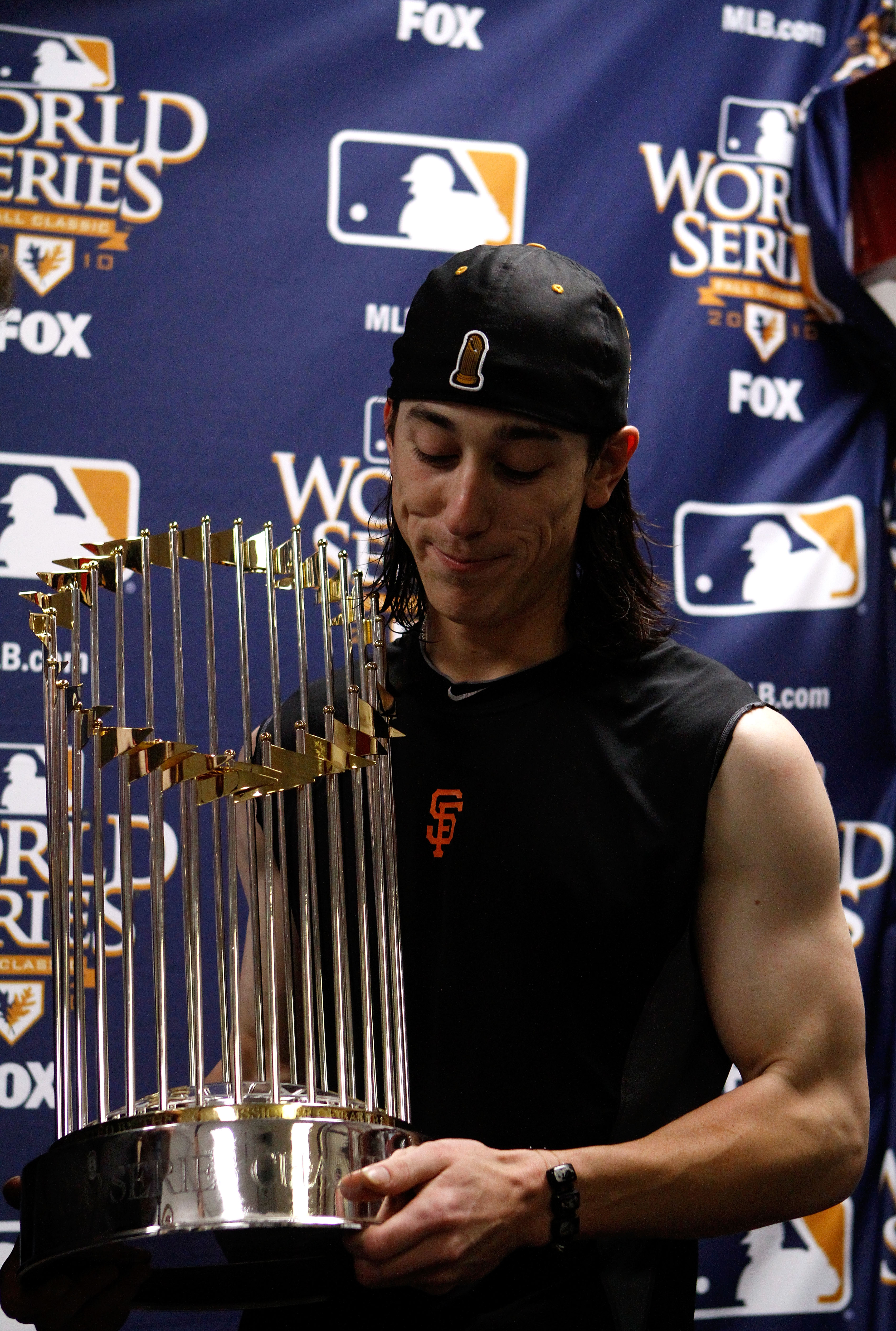ARLINGTON, TX - NOVEMBER 01:  Tim Lincecum #55 of the San Francisco Giants celebrates with the World Series trophy in the locker room after the Giants won 3-1 against the Texas Rangers in Game Five of the 2010 MLB World Series at Rangers Ballpark in Arlin