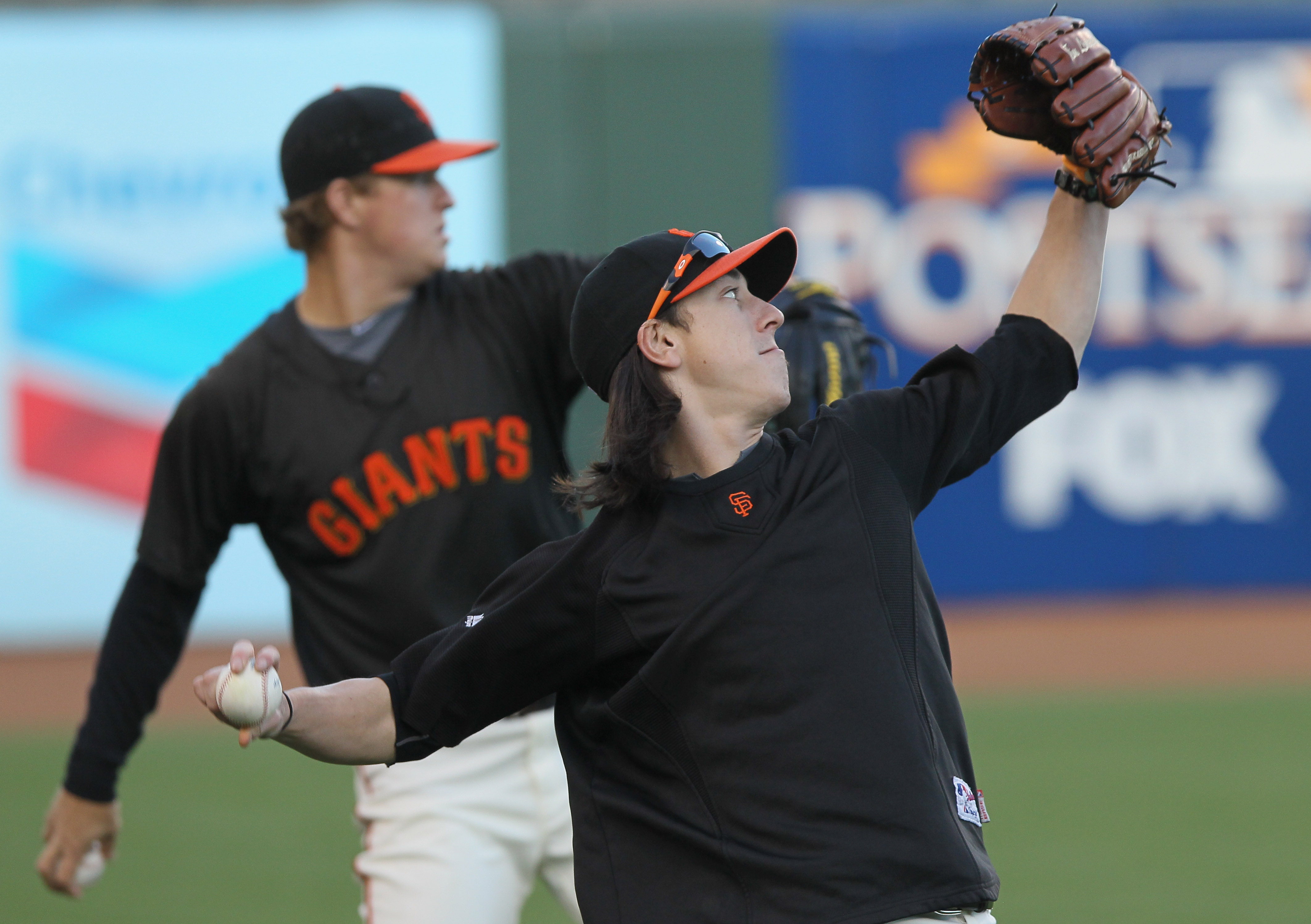 SAN FRANCISCO - OCTOBER 25:  Tim Lincecum #55 of the San Francisco Giants throws alongside teammate Matt Cain #18 during a team workout at AT&T Park on October 25, 2010 in San Francisco, California. The Giants are preparing to face the Texas Rangers in th