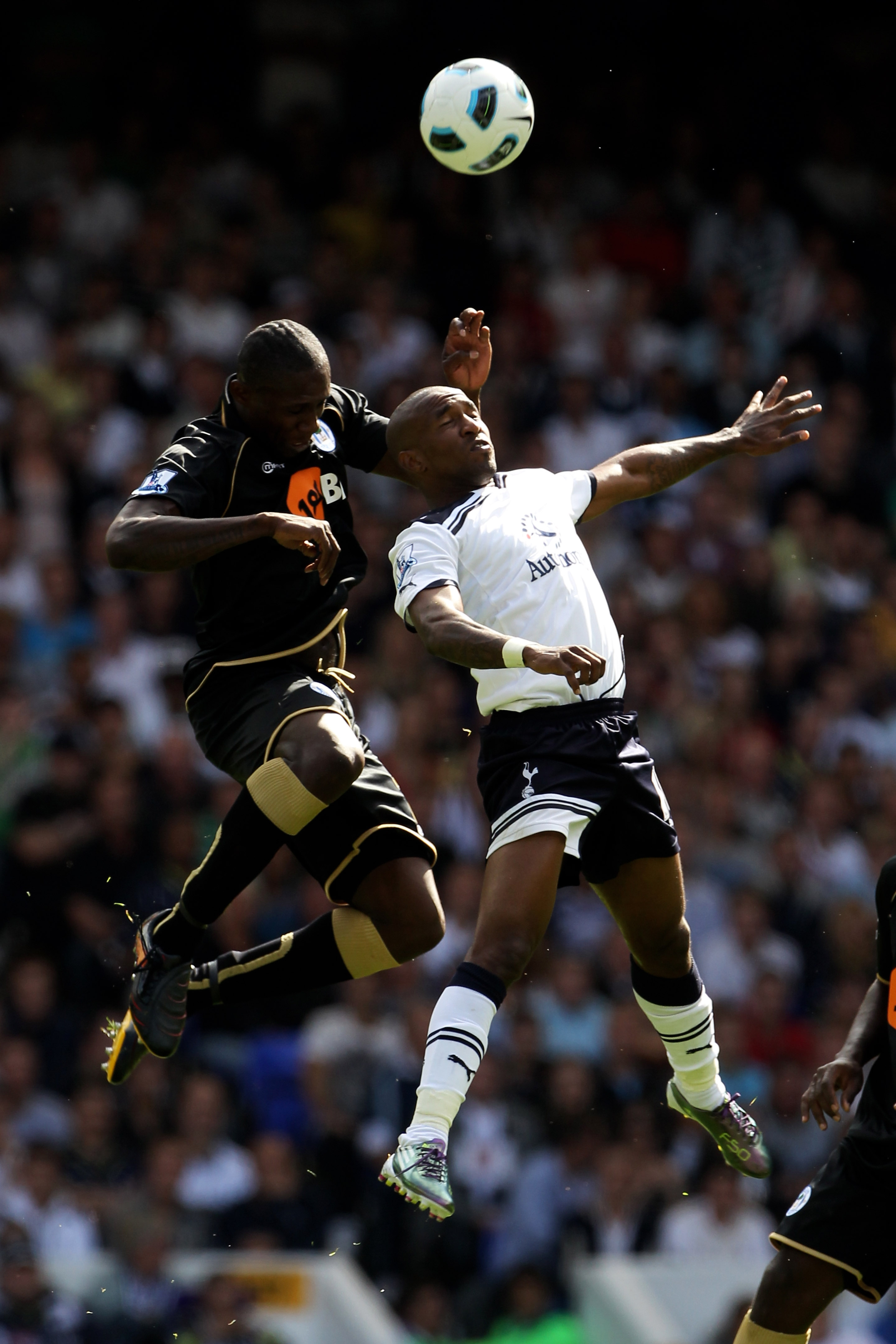 LONDON, ENGLAND - AUGUST 28:  Jermain Defoe of Tottenham battles for the header with Steve Gohouri of Wigan during the Barclays Premier League match between Tottenham Hotspur and Wigan Athletic at White Hart Lane on August 28, 2010 in London, England.  (P