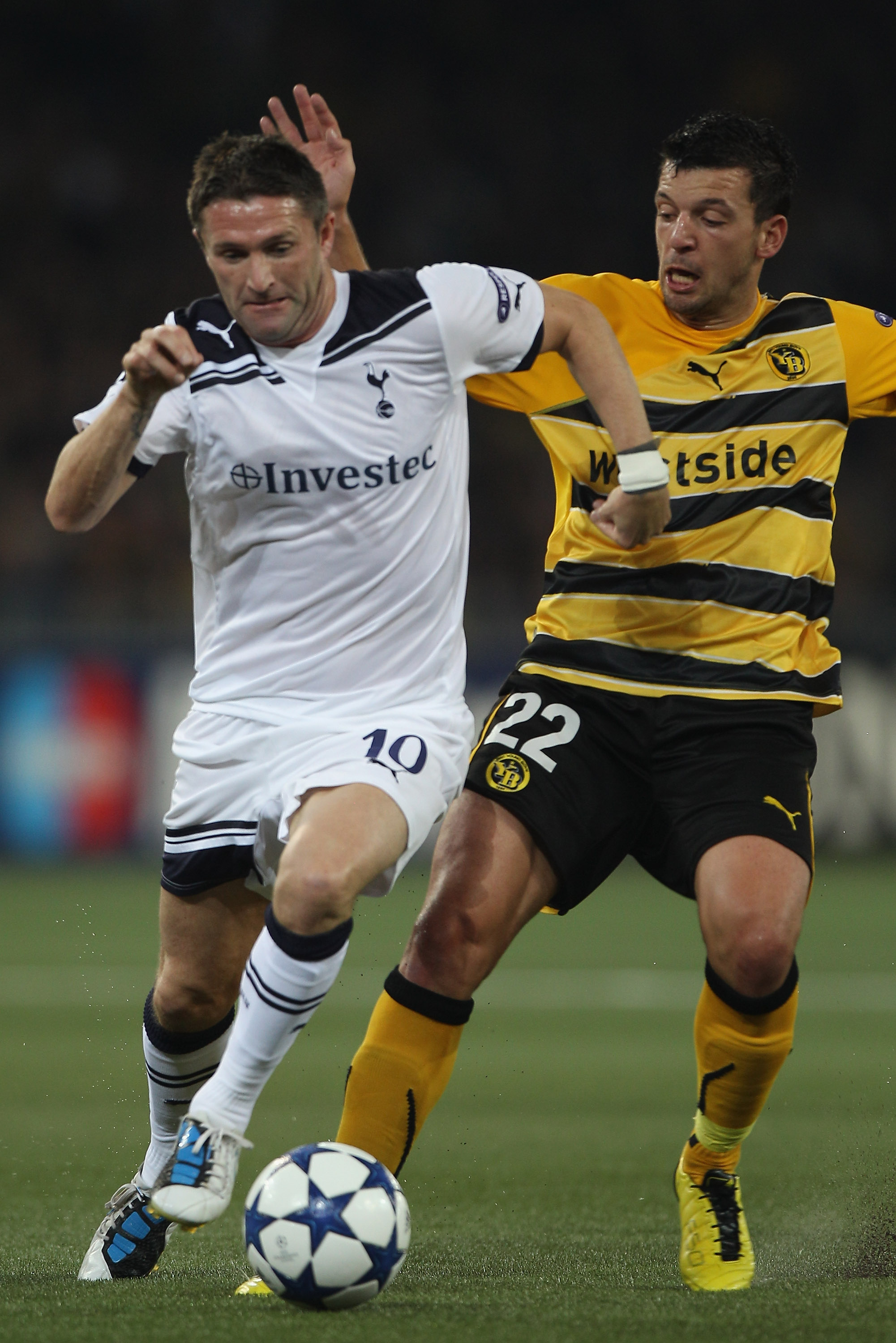 BERNE, SWITZERLAND - AUGUST 17:  Robbie Keane (l) of Tottenham takes on Xavier Hochstrasser during the UEFA Champions League Play-Off first leg match between BSC Young Boys and Tottenham Hotspur at the Stade de Suisse on August 17, 2010 in Berne, Switzerl