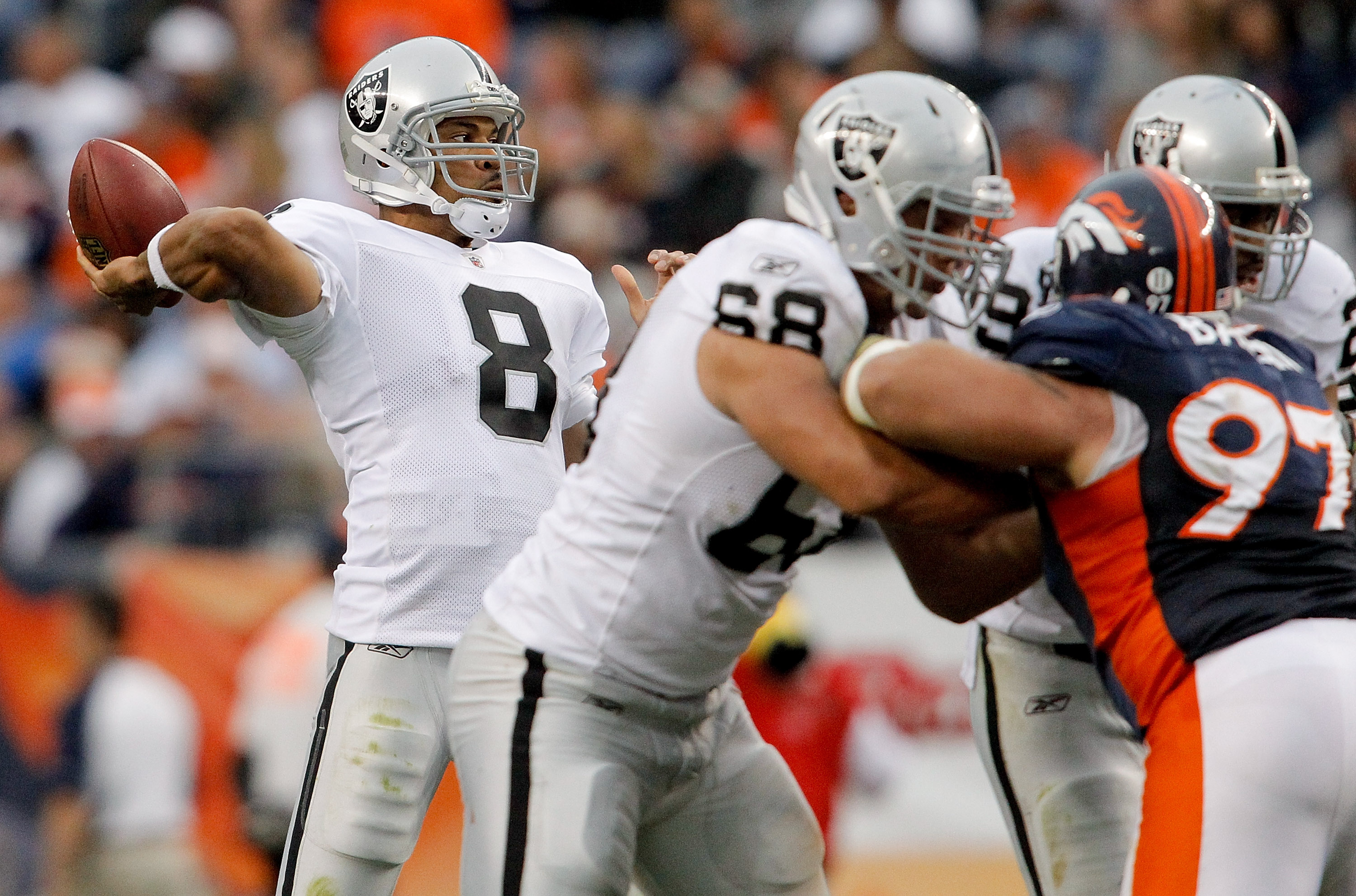 DENVER - OCTOBER 24:  Quarterback Jason Campbell #8 of the Oakland Raiders makes a pass against the Denver Broncos in the third quarter at INVESCO Field at Mile High on October 24, 2010 in Denver, Colorado. The Raiders defeated the Broncos 59-14. (Photo b