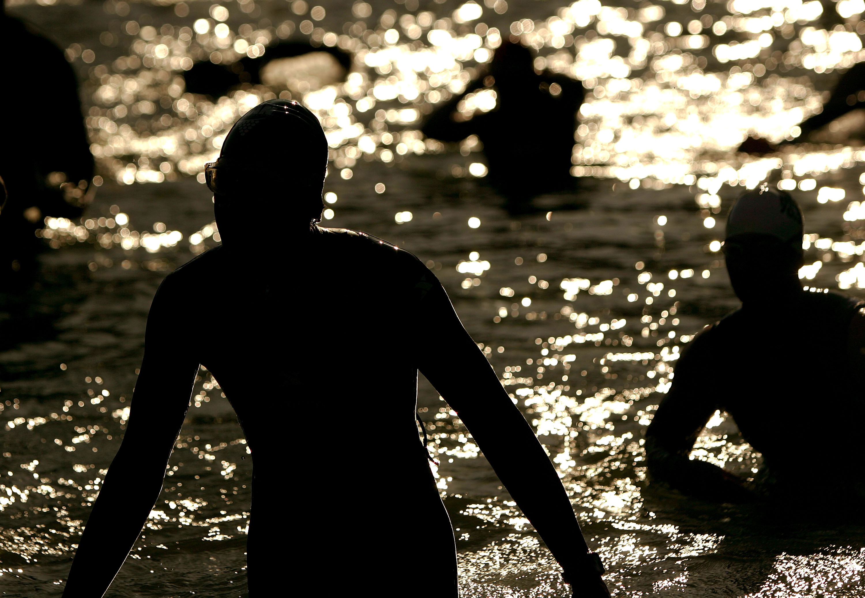 SANTA ROSA, CA - JULY 19: Athletes exit the water after finishing the 1.2 mile swim in the Vineman Ironman 70.3 on July 19, 2009 in Santa Rosa, California. The Vineman Ironman 70.3 Triathlon, which is held in Sonoma County, California (about one hour nort