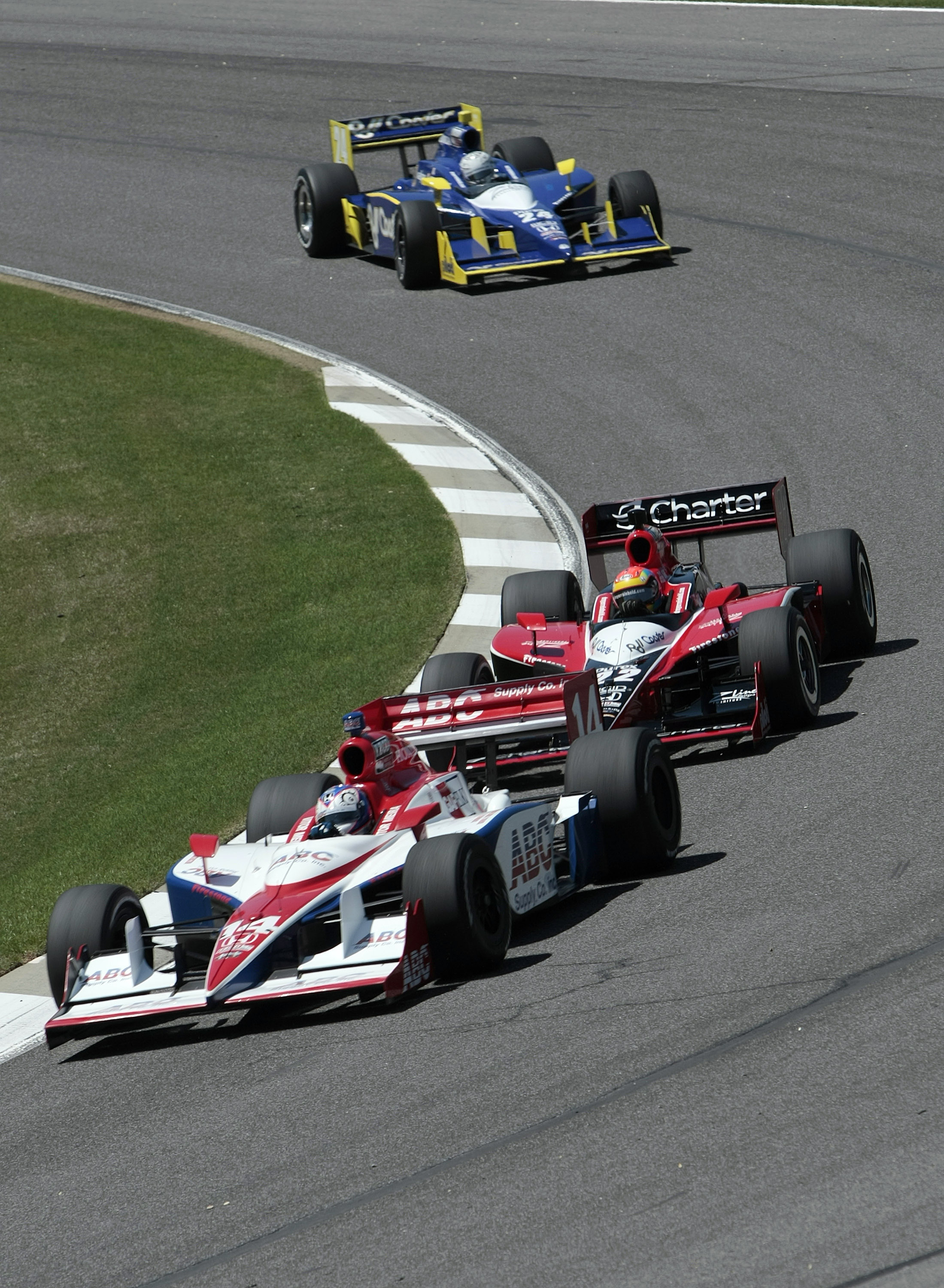 LEEDS, AL - APRIL 09: Vitor Meira #14 of Brazil leads Justin Wilson #22 of England and Mike Conway #24 of England thru turn two during practice for the IRL IndyCar Series Grand Prix of Alabama at the Barber Motorsports Park on April 9, 2010 in Leeds, Al