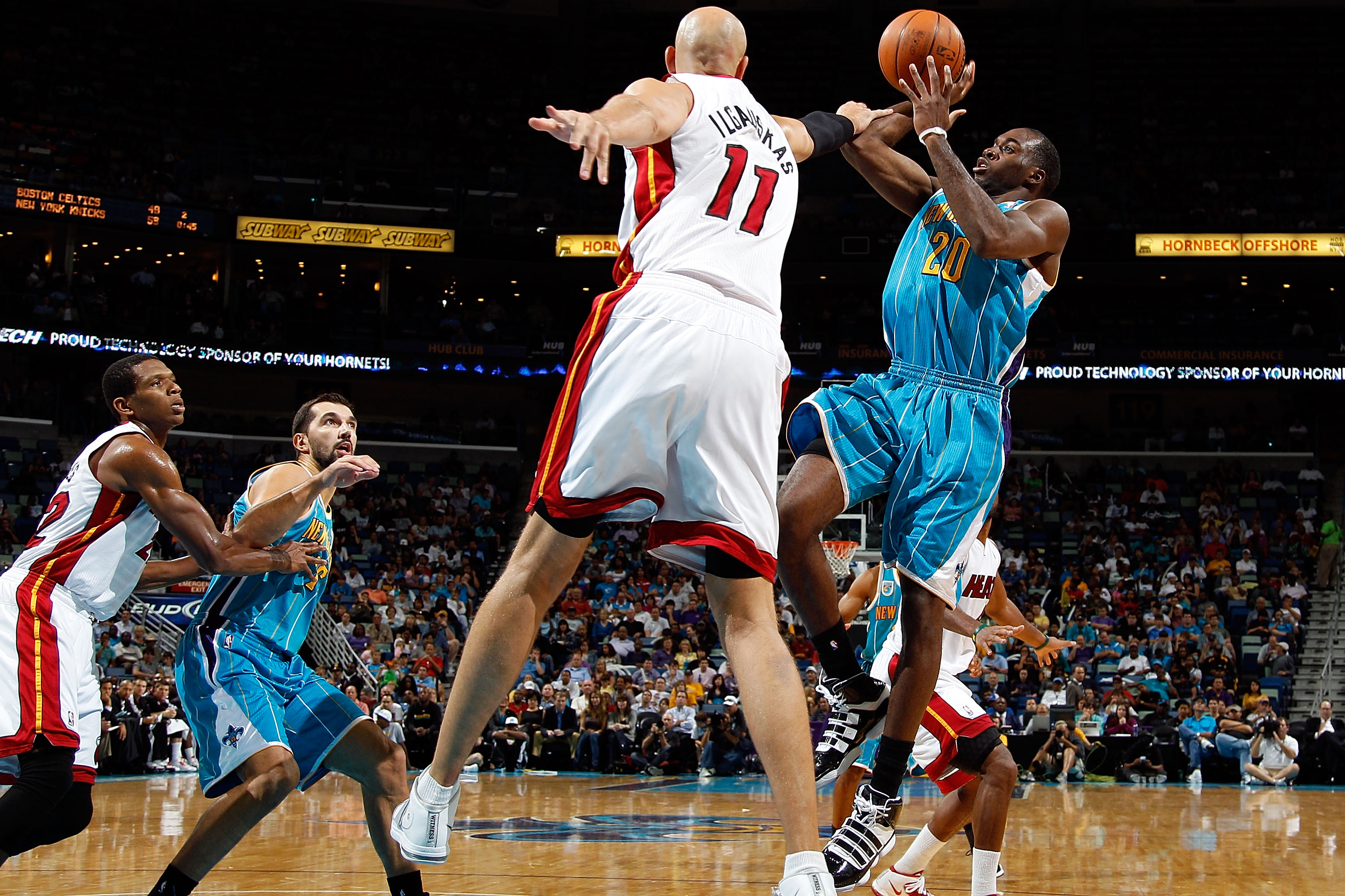 NEW ORLEANS - OCTOBER 13: Zydrunas Ilgauskas #11 of the Miami Heat tries to block the shot of Quincy Pondexter #20 of the New Orleans Hornets at the New Orleans Arena on October 13, 2010 in New Orleans, Louisiana. NOTE TO USER: User expressly acknowledg